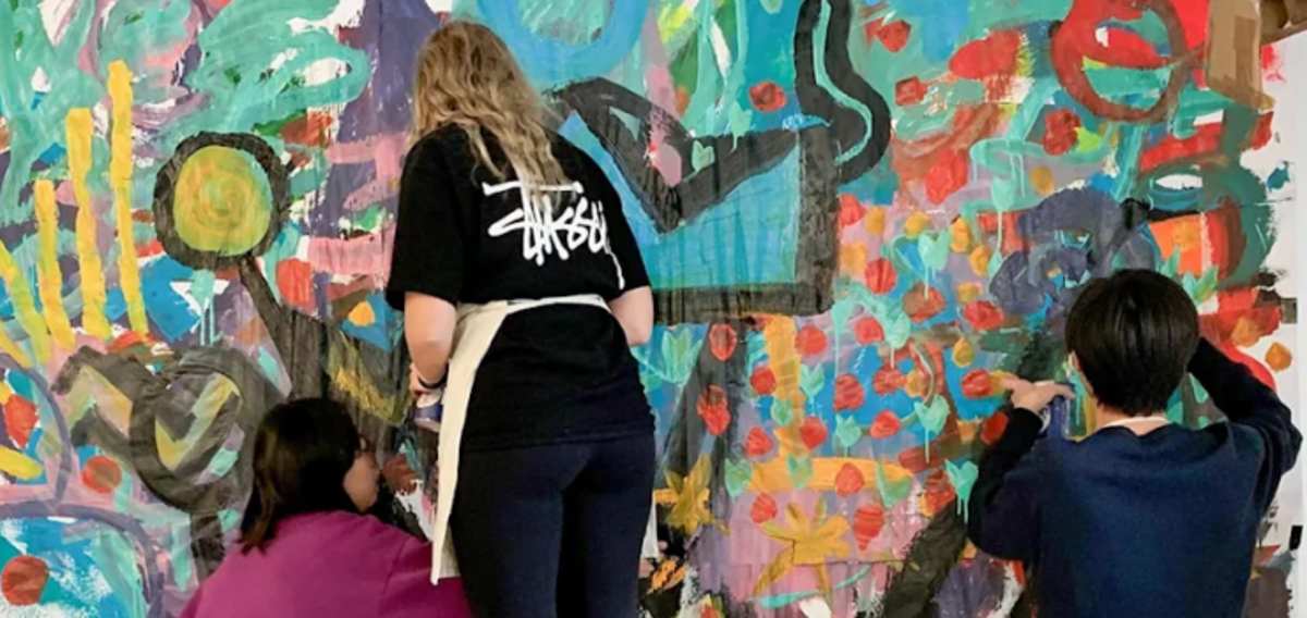 Art students working on large art piece 
