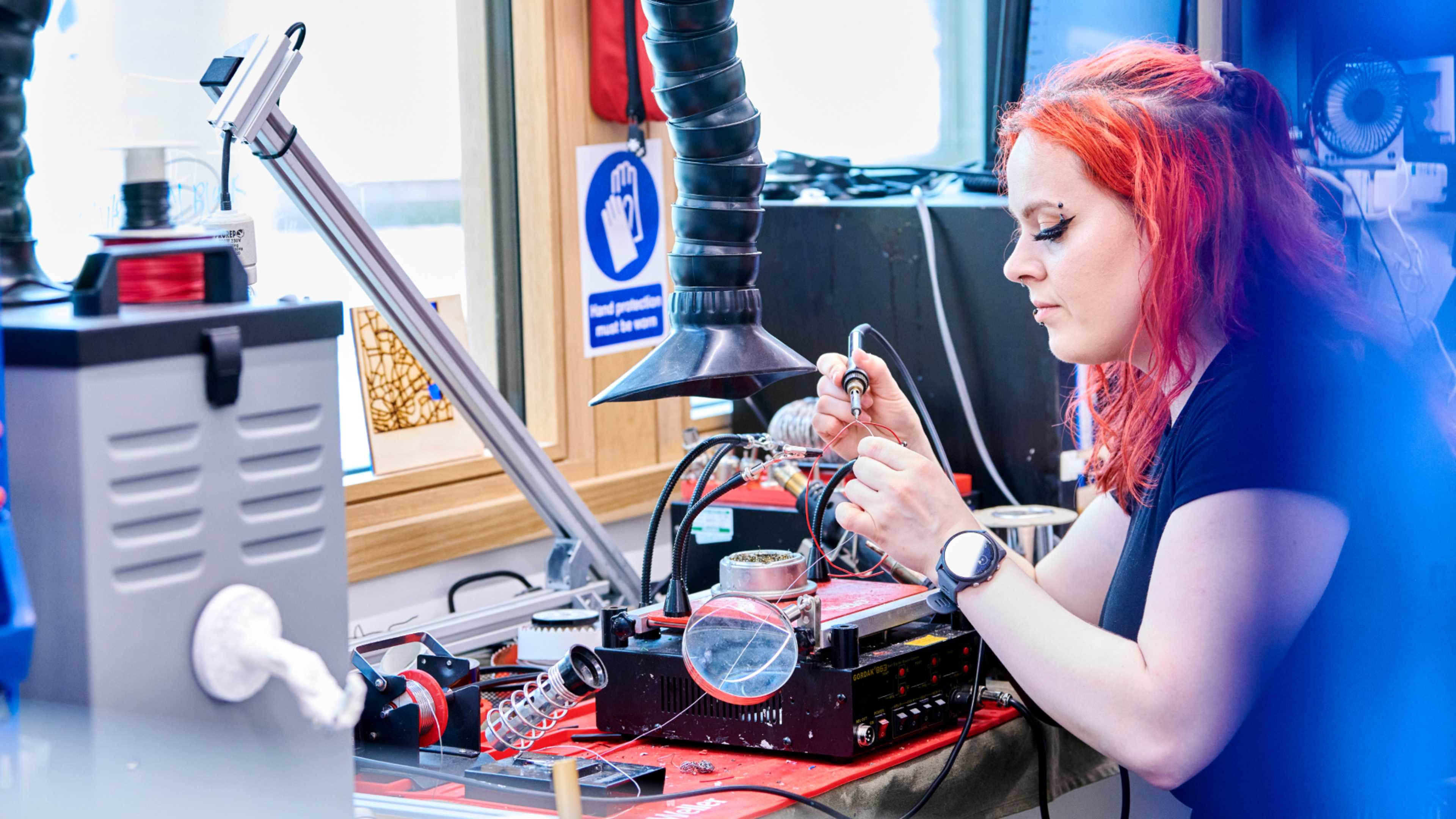 Female computer science student assembling parts
