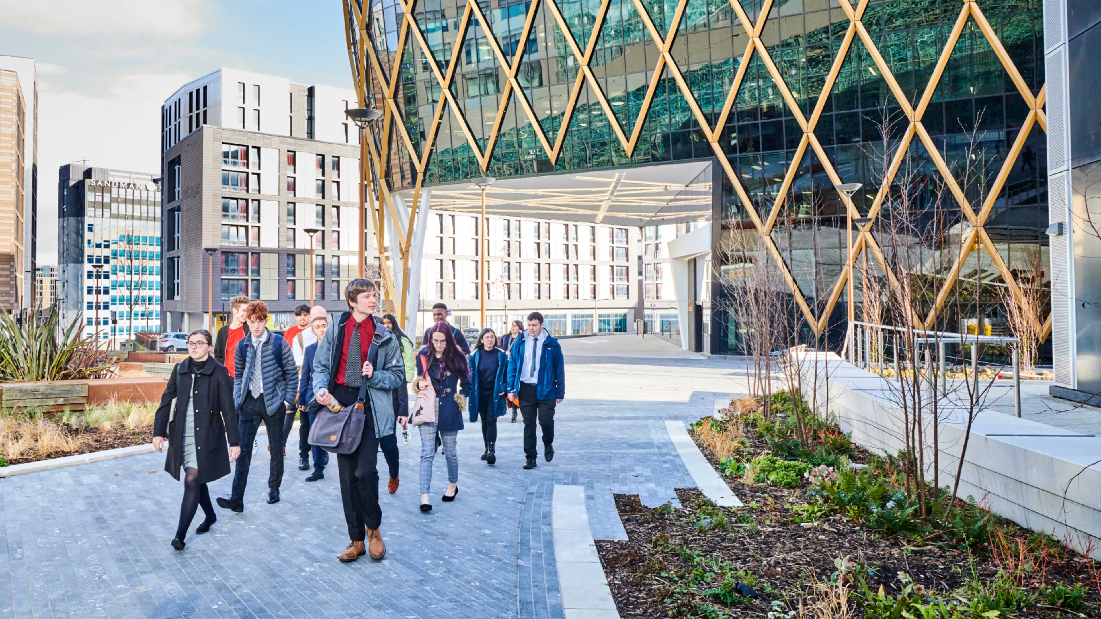 Diverse group of students walking outside the Helix