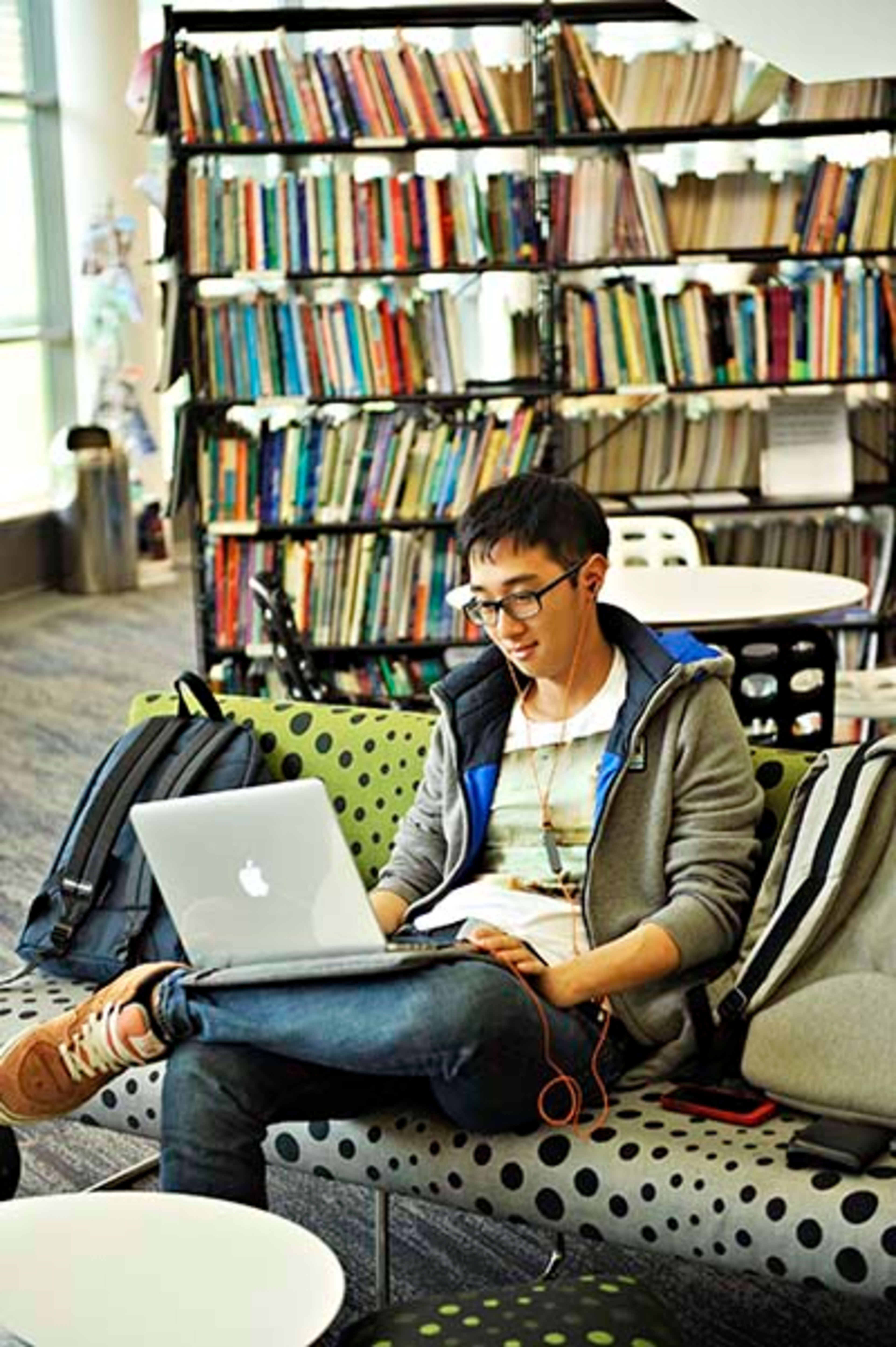 International student working in Learning Resource Centre with laptop