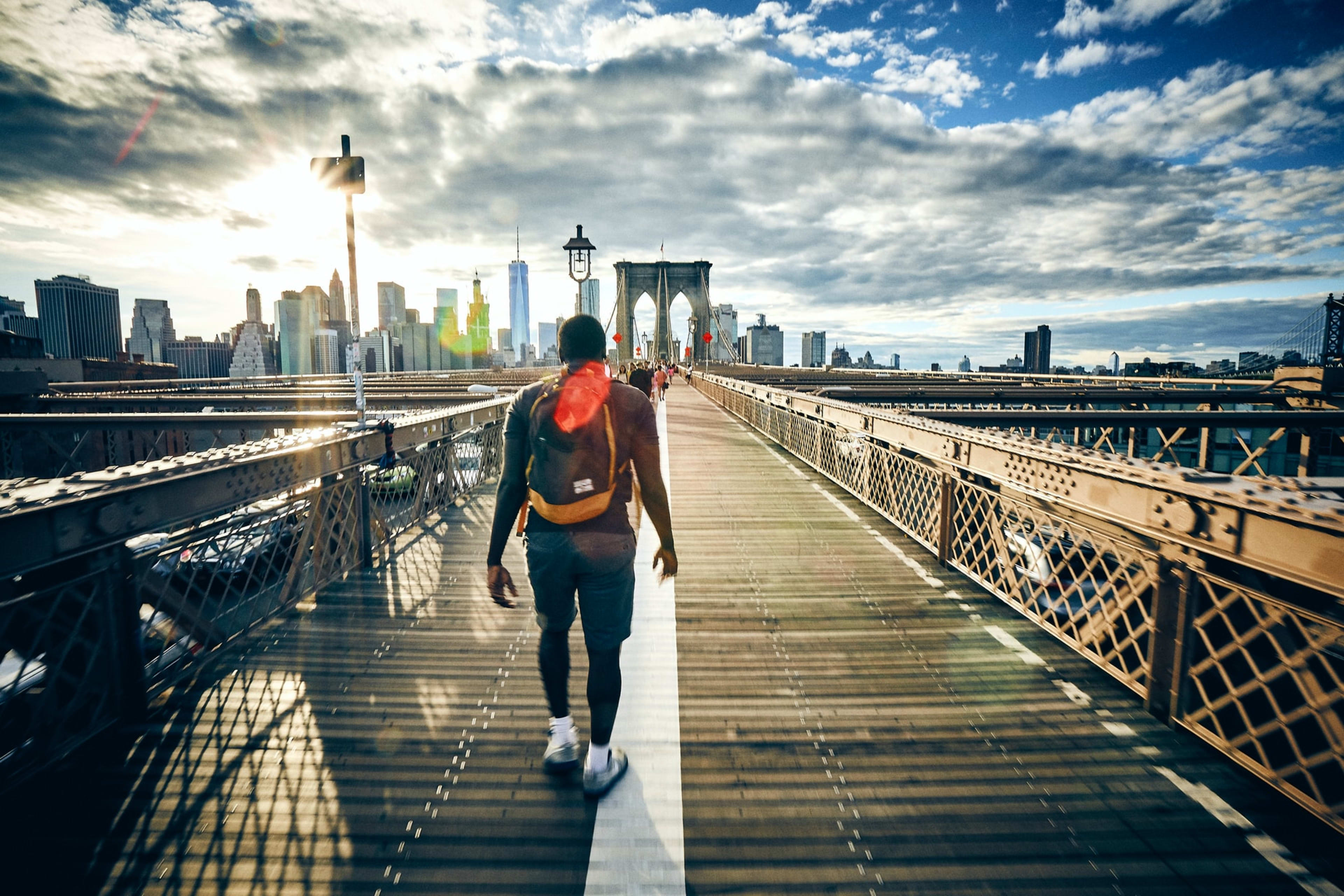 Student walking across bridge to Manhattan