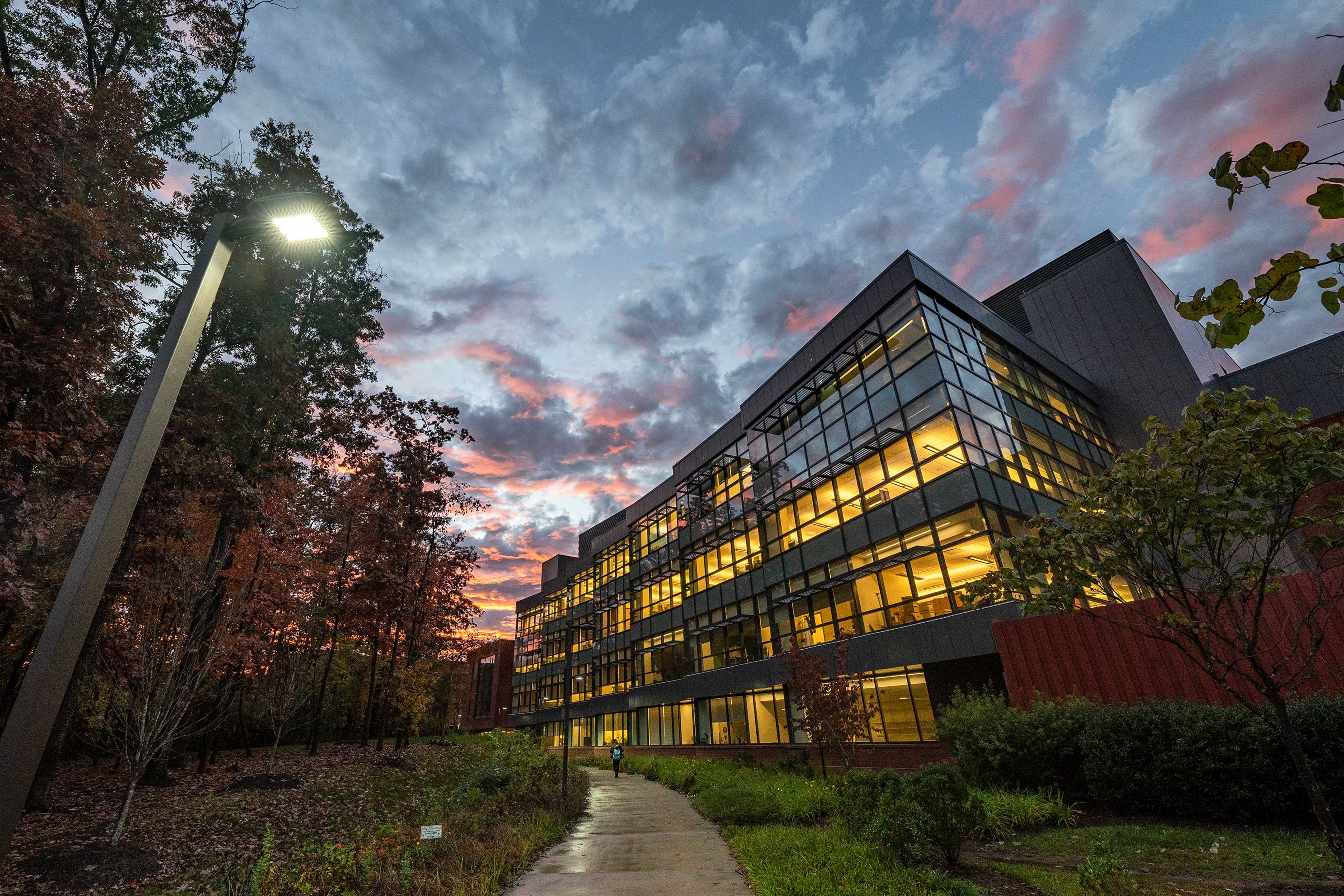George Mason University student in front of campus building