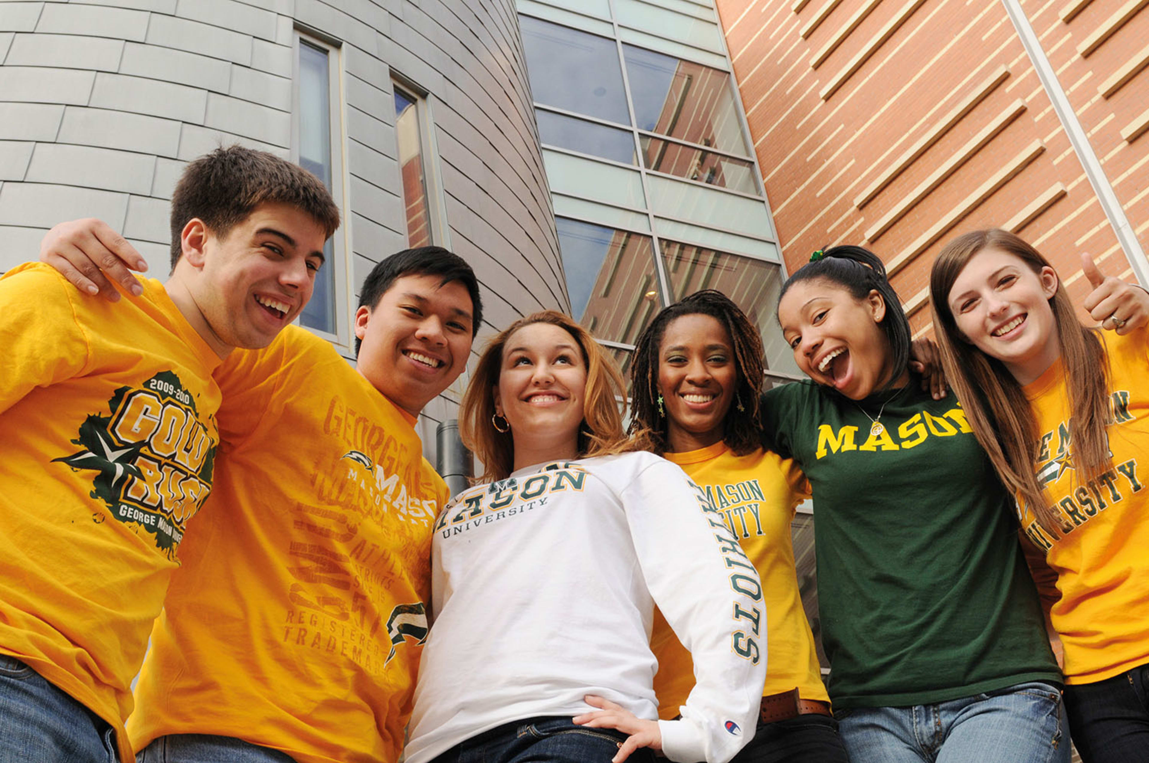 Smiling George Mason students posing for the camera