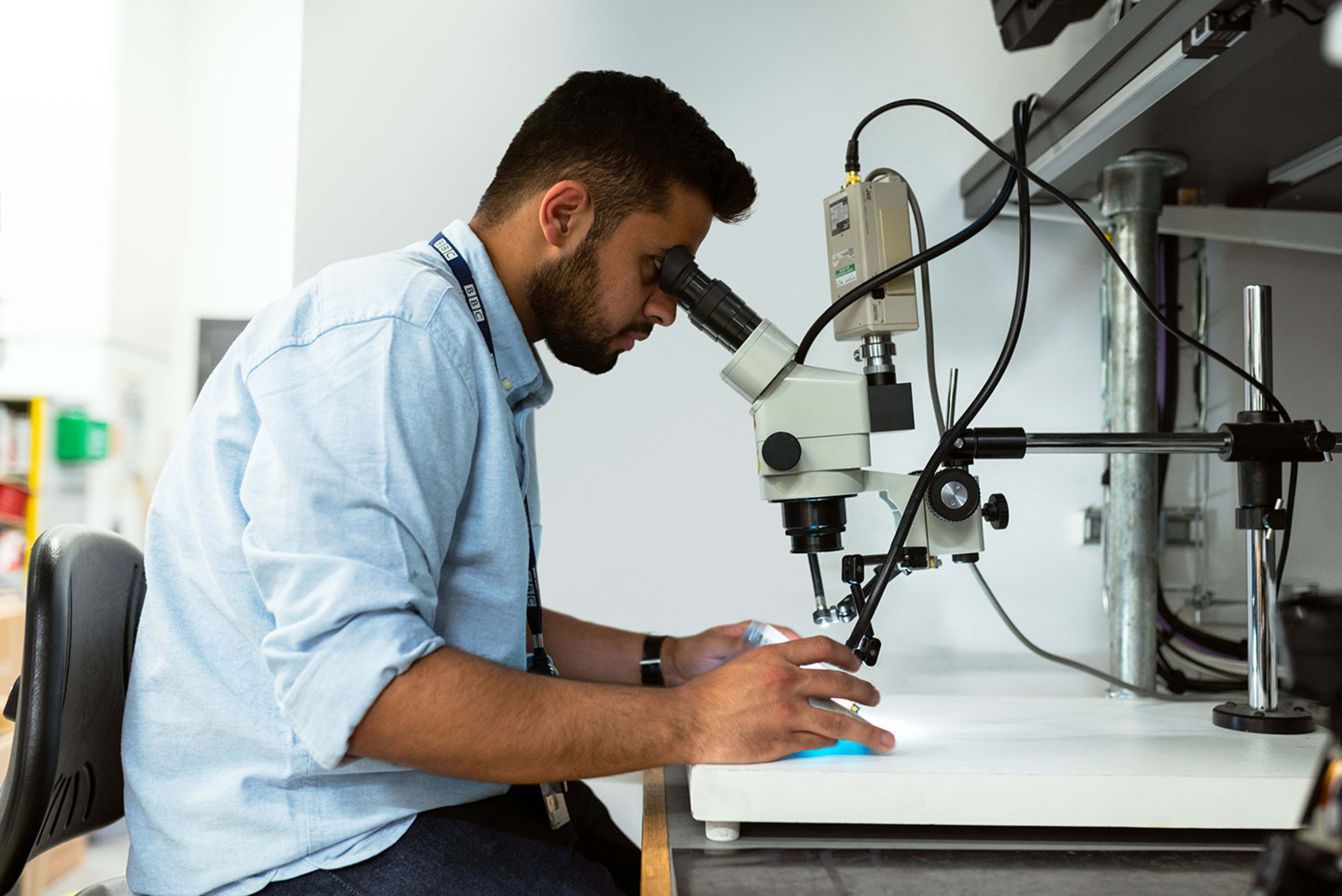 Science student using a microscope