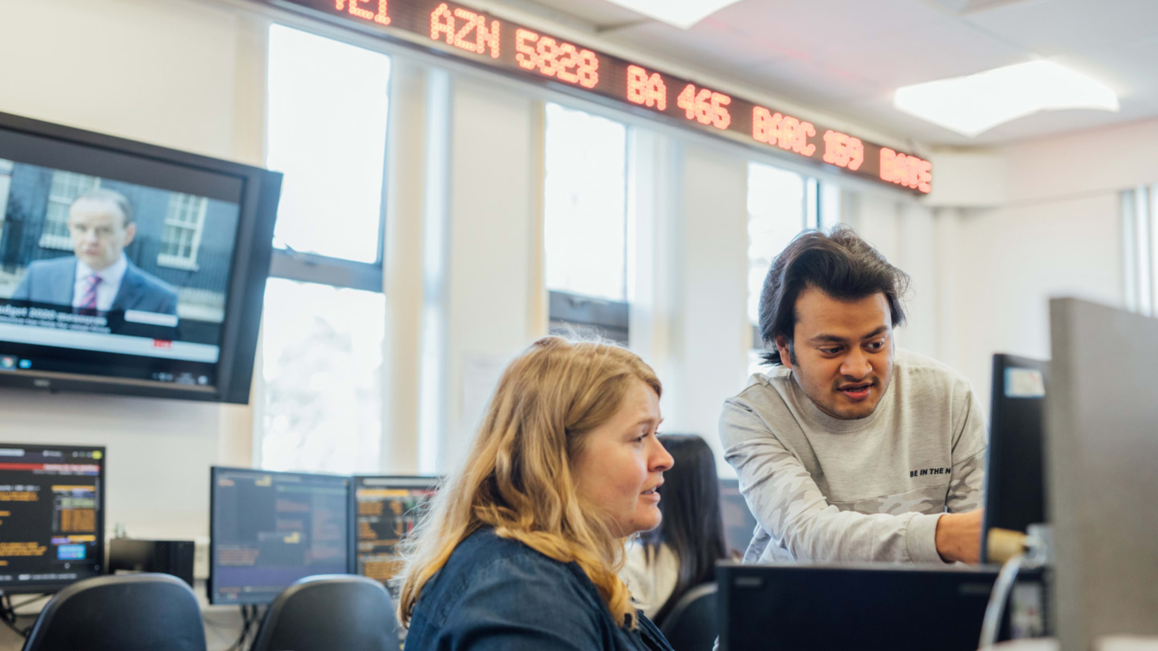 Teacher and student in Financial Trading Room