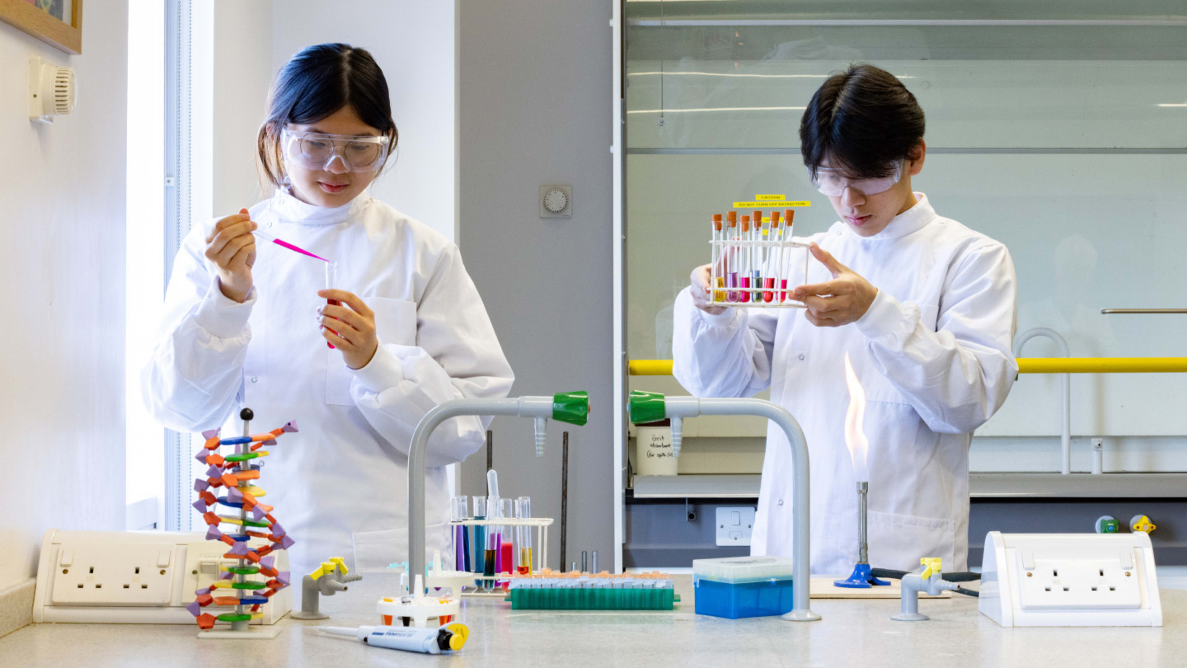 Image of students using science equipment in lab