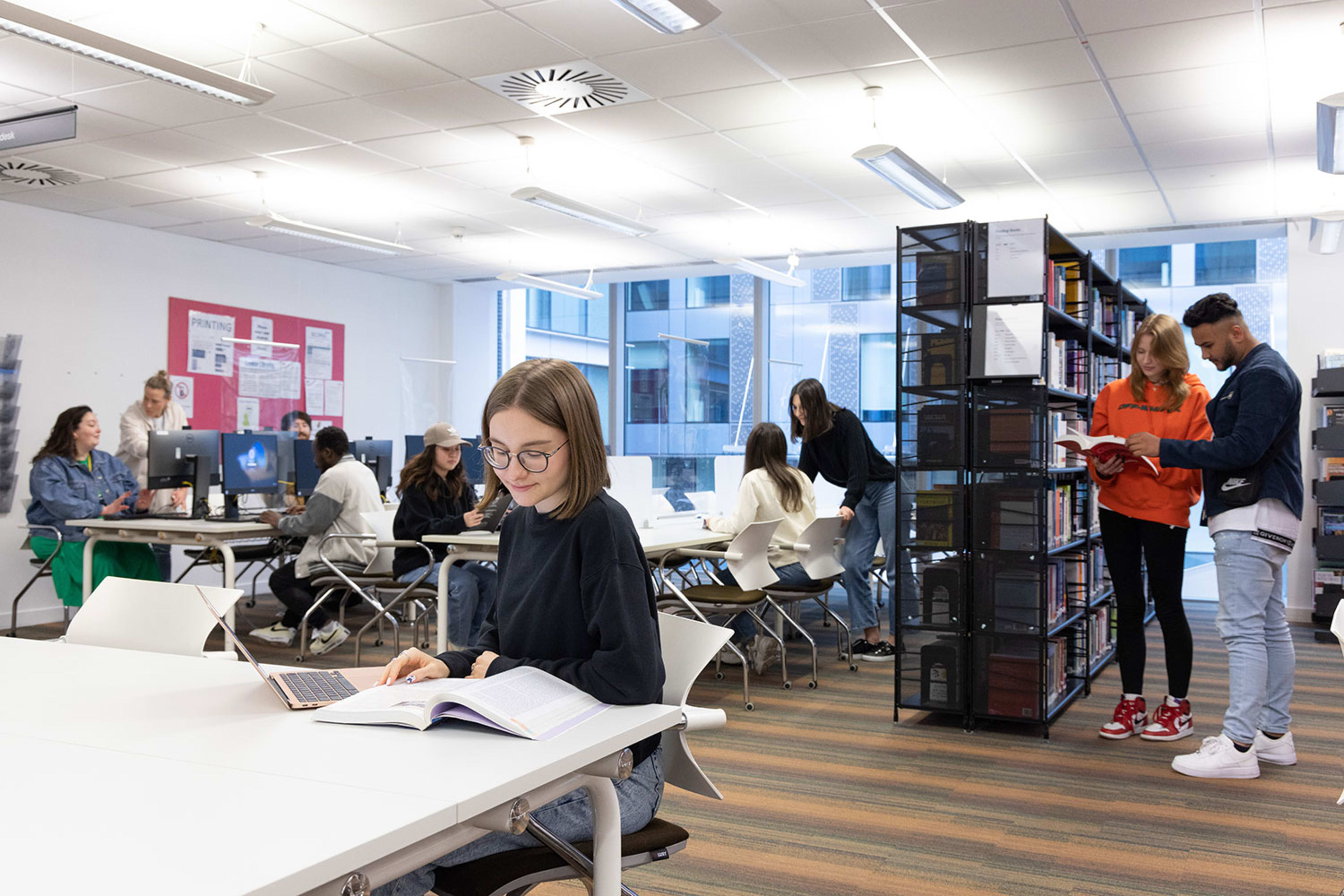Students studying in the library at INTO London
