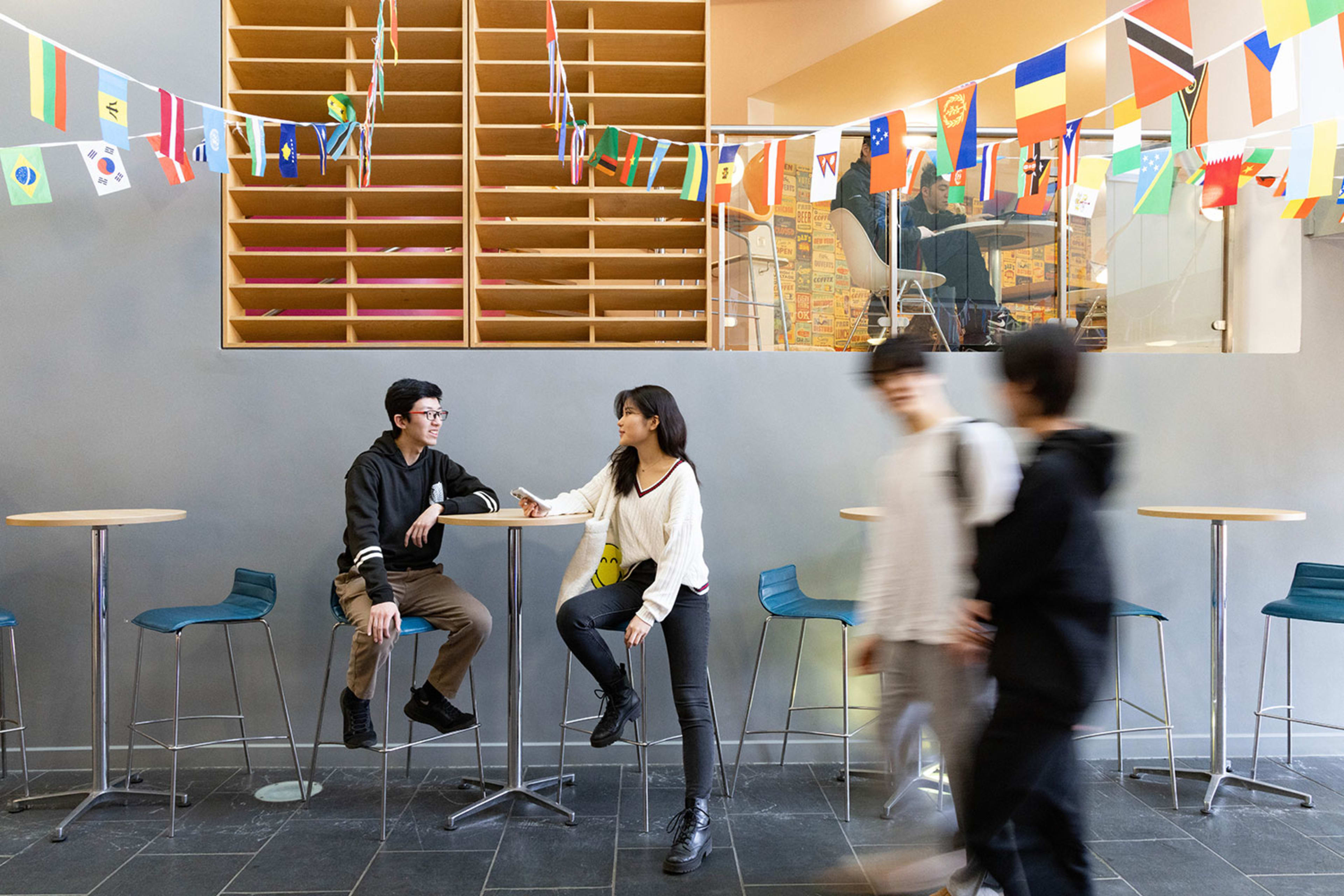 Students socialising in a common space at INTO UEA