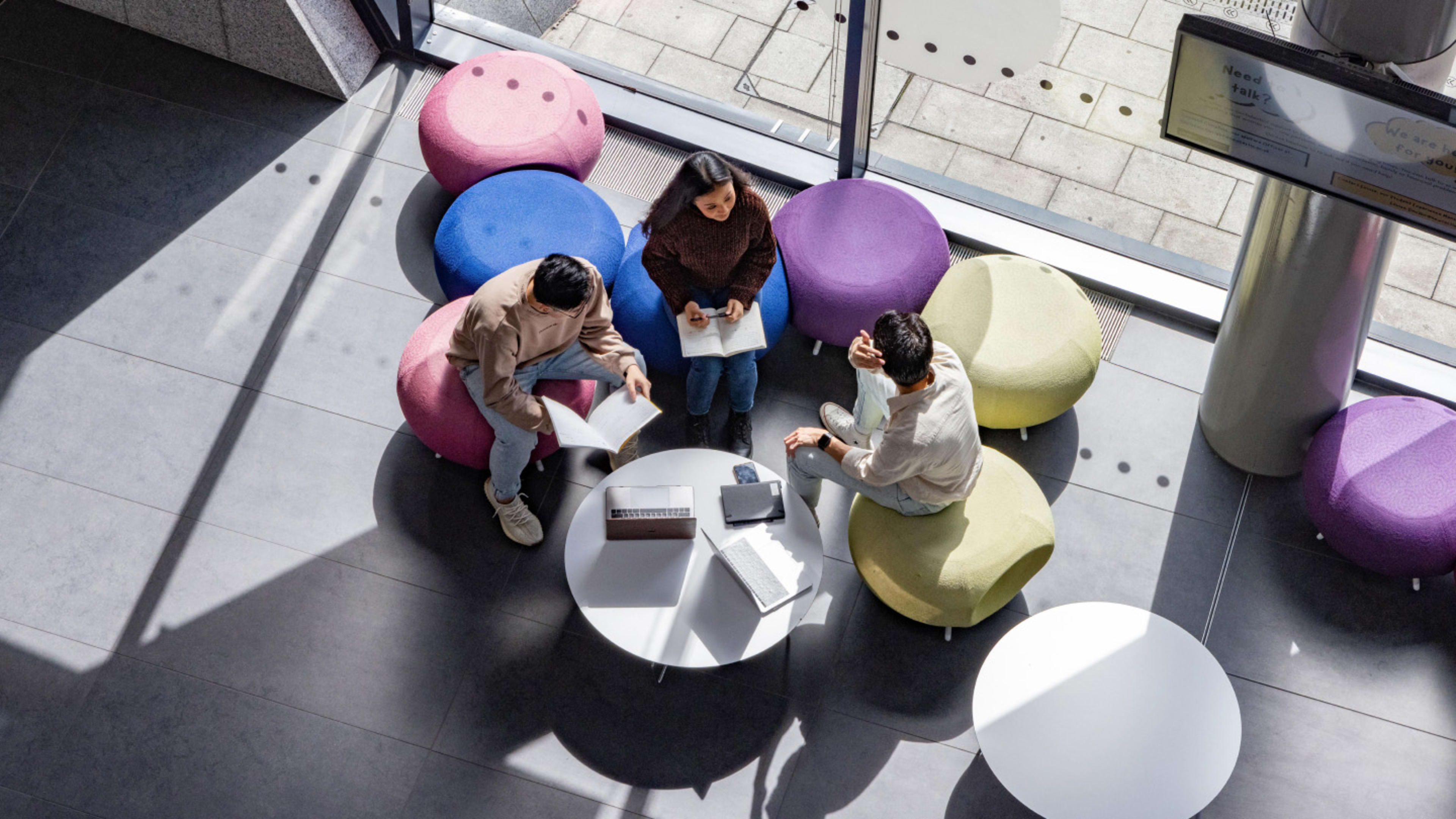 Aerial view of students sitting and working in social space