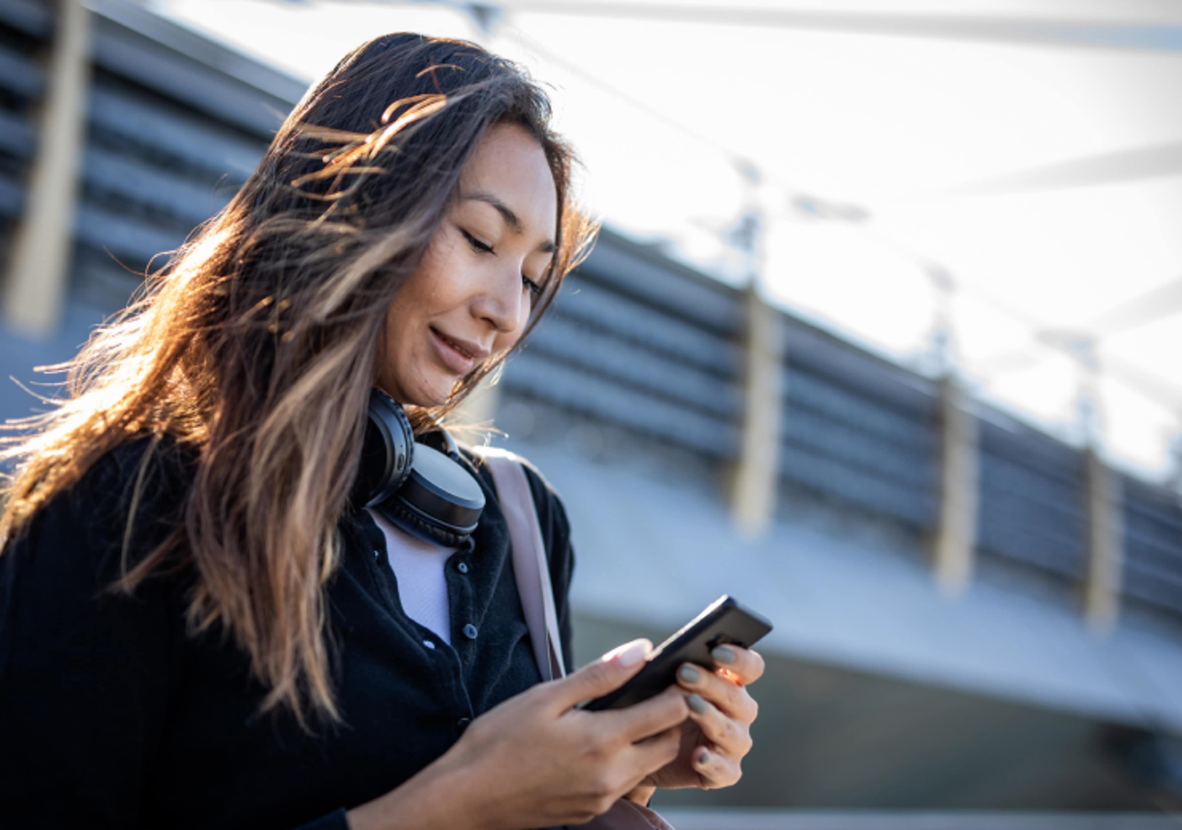 Young Asian woman using phone to send an email