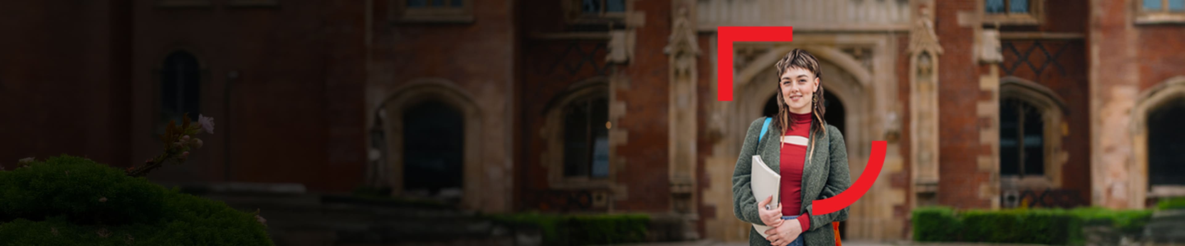 Ambitious student standing in front of Queen's University building