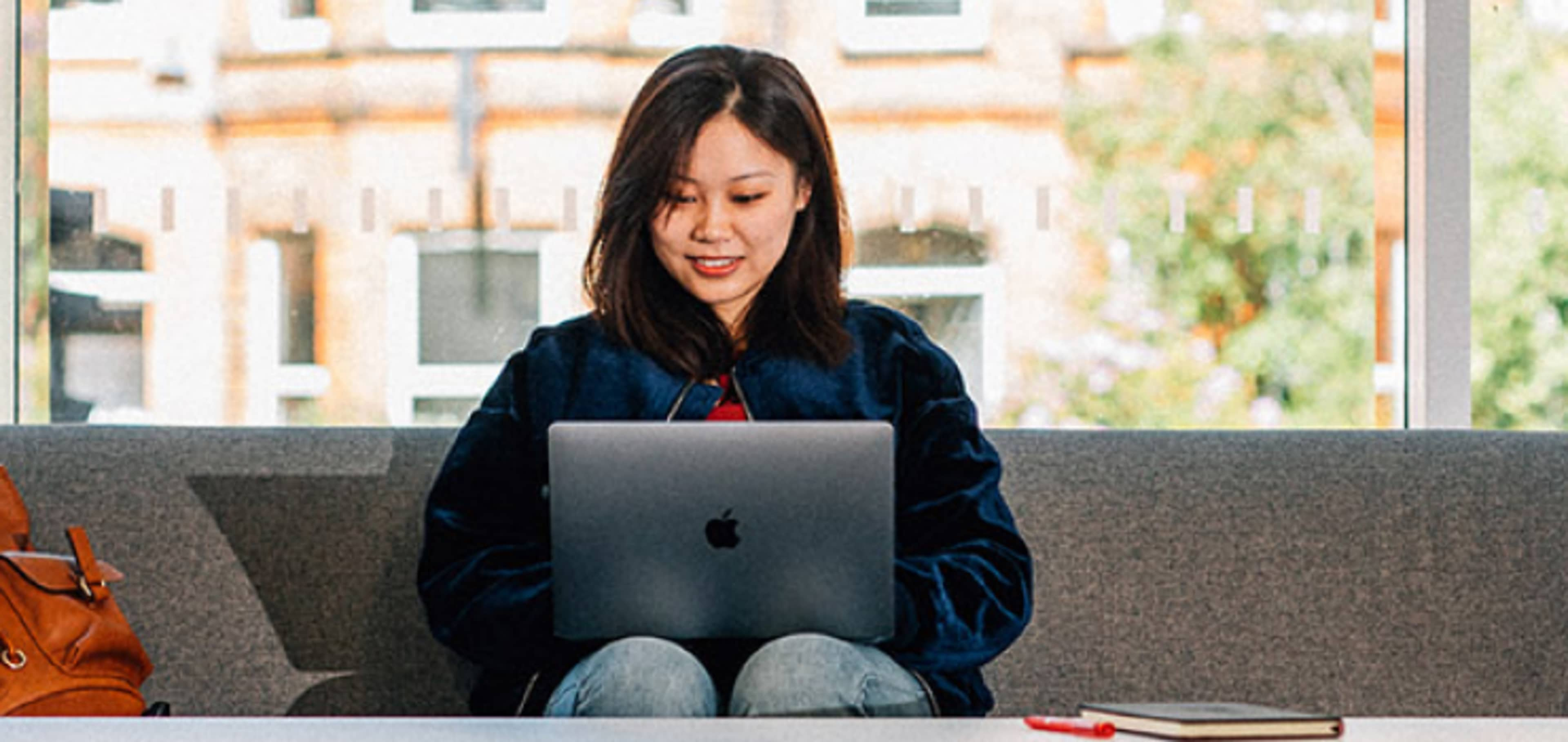 Under graduate student working on laptop at Queen's University Belfast