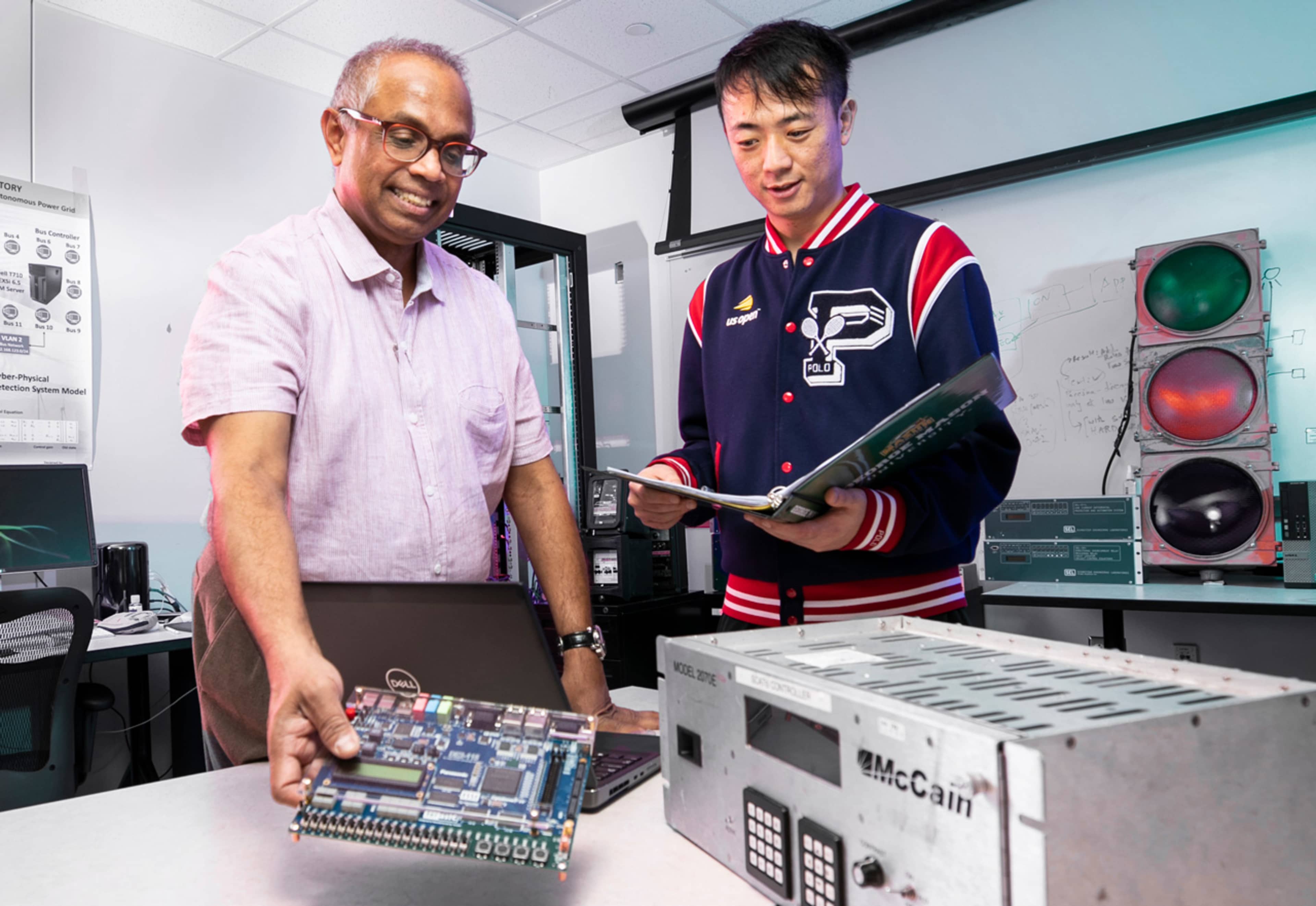 Student and faculty member talking in computer lab