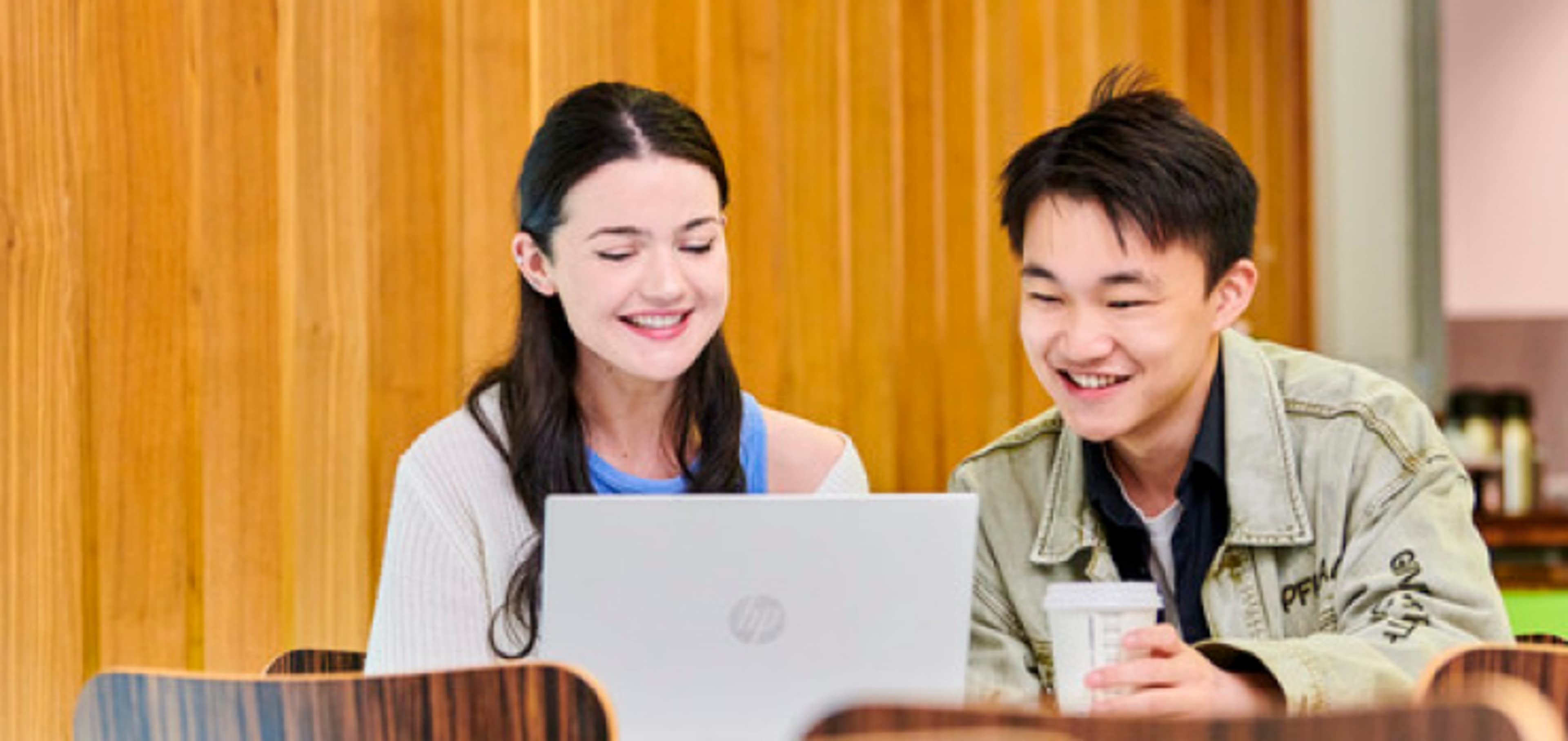 Newcastle International Study Centre students working together looking at laptop screen