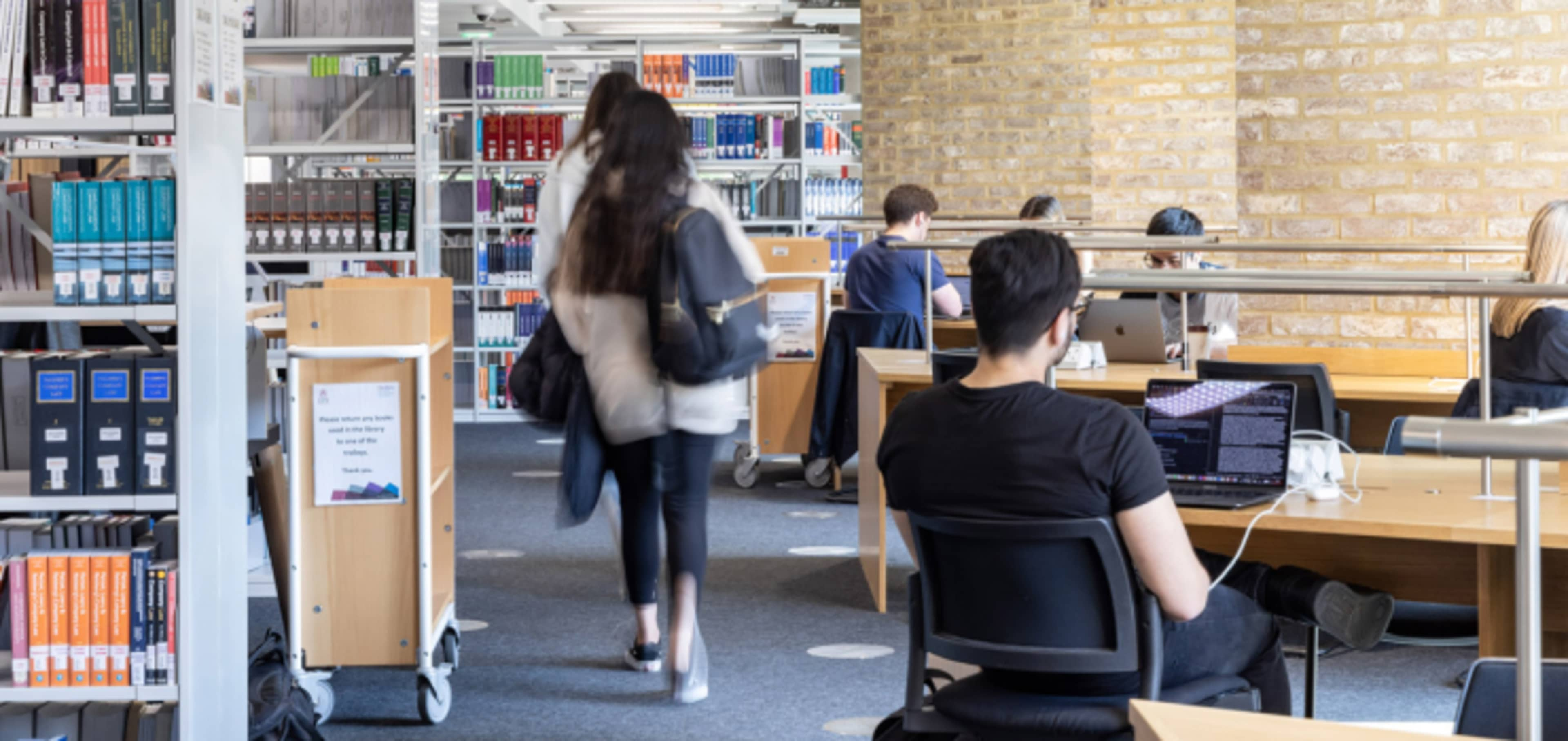 English language students working in City library 