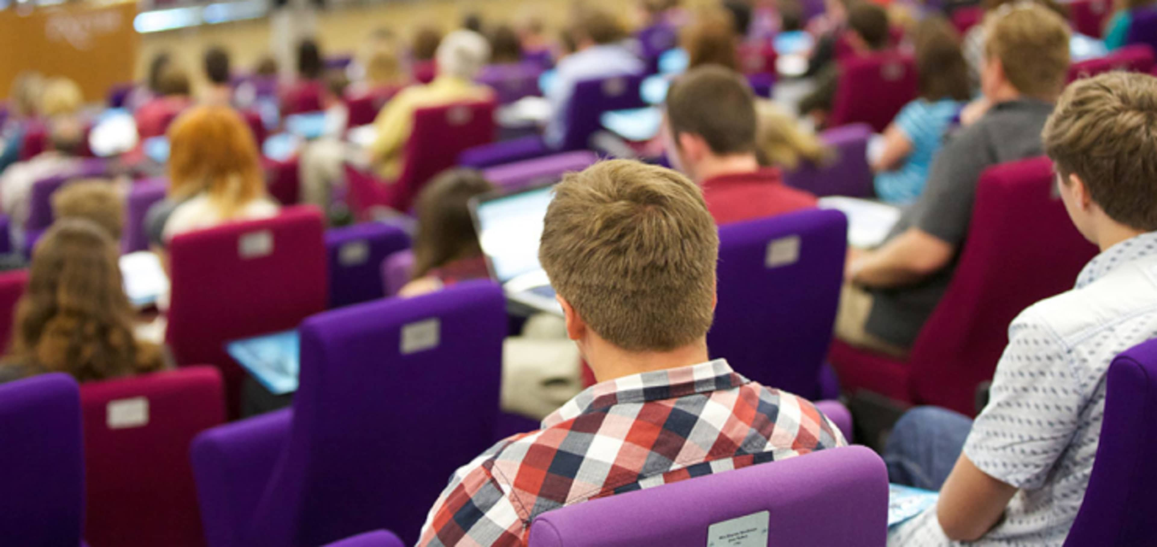 Class of postgraduate students in lecture theatre 