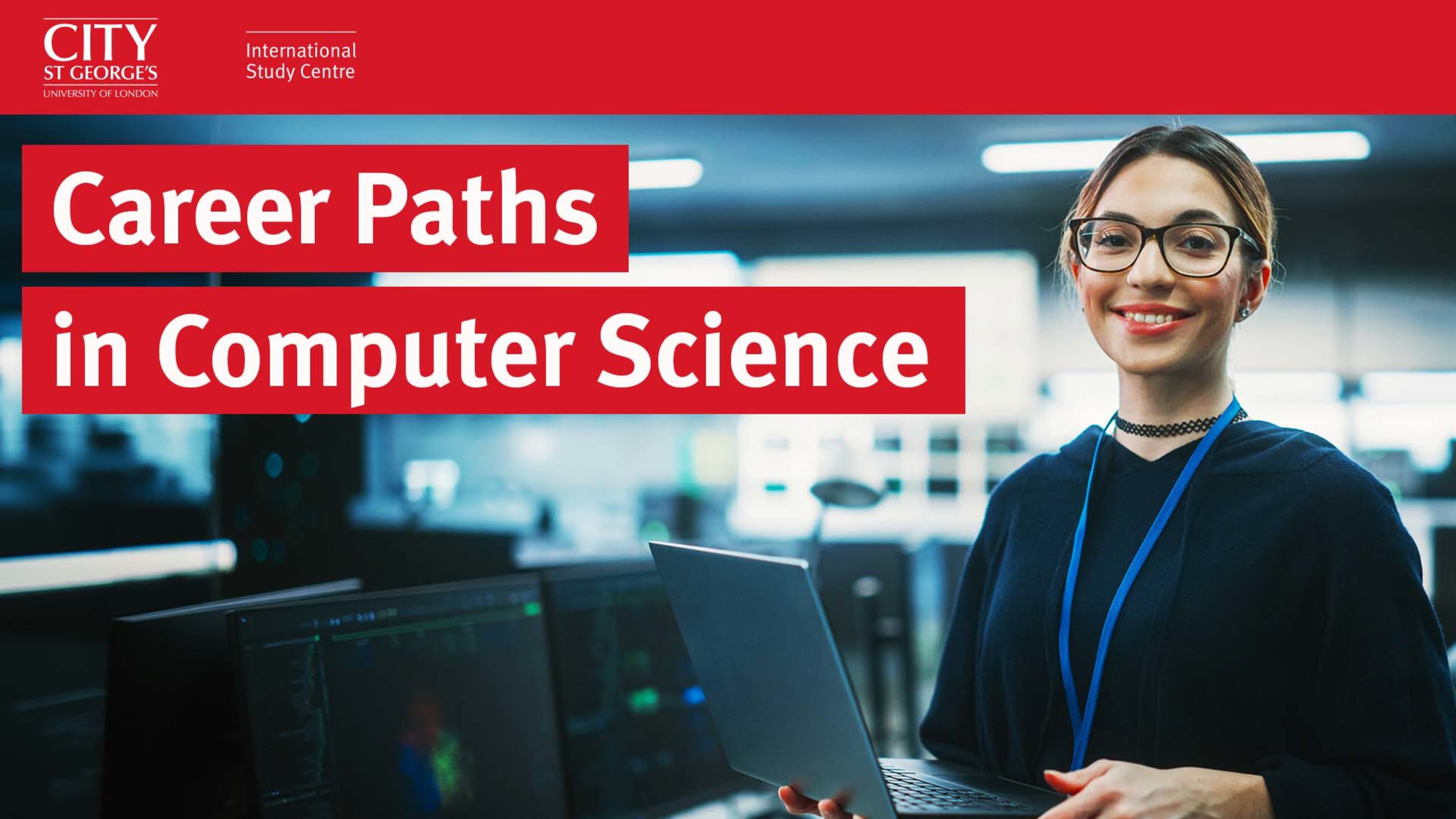 Female student in a computer lab holding a laptop 