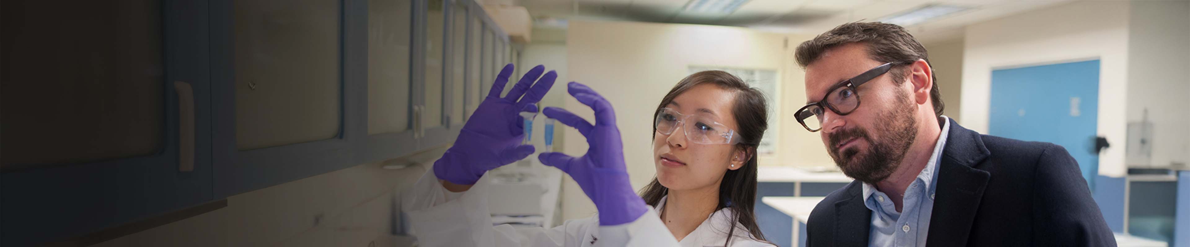 OSU student and professor in science lab