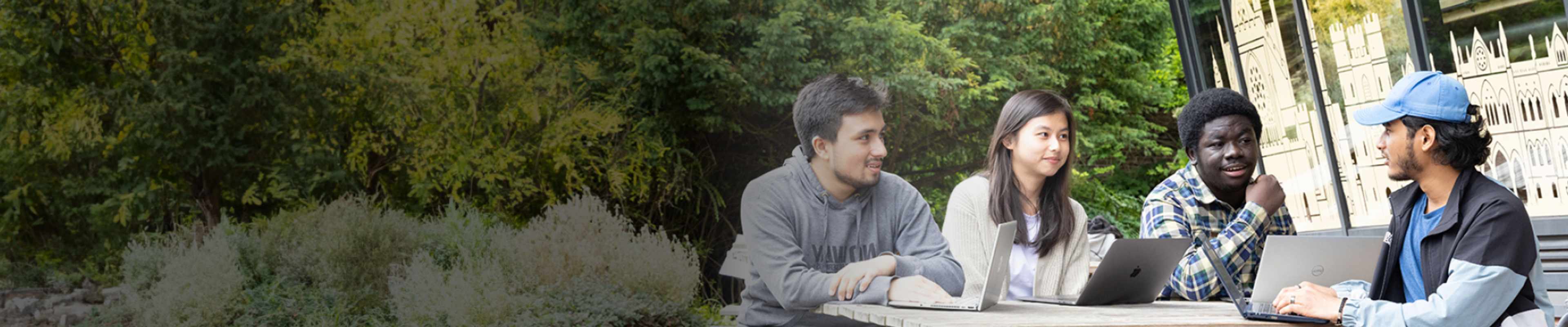 Students sitting together on bench outside