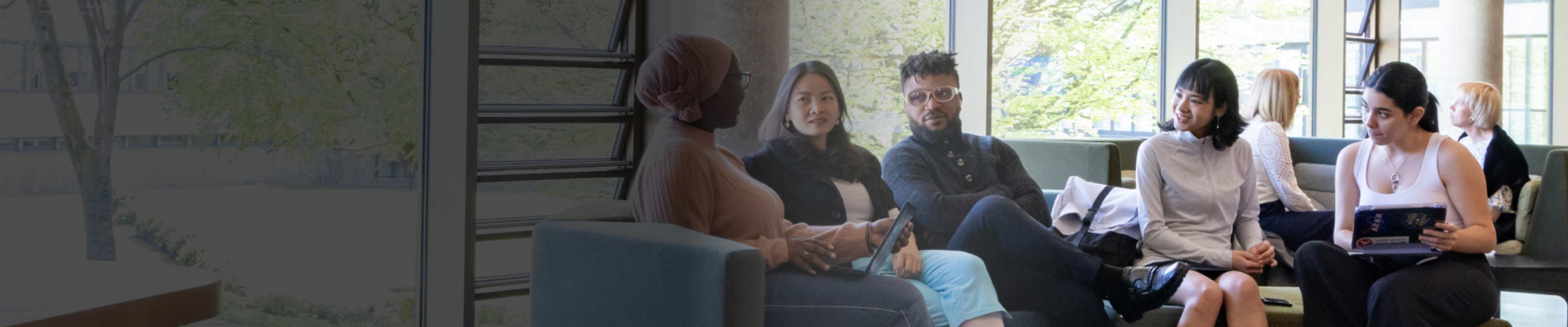 Group of students sitting on sofa, chatting