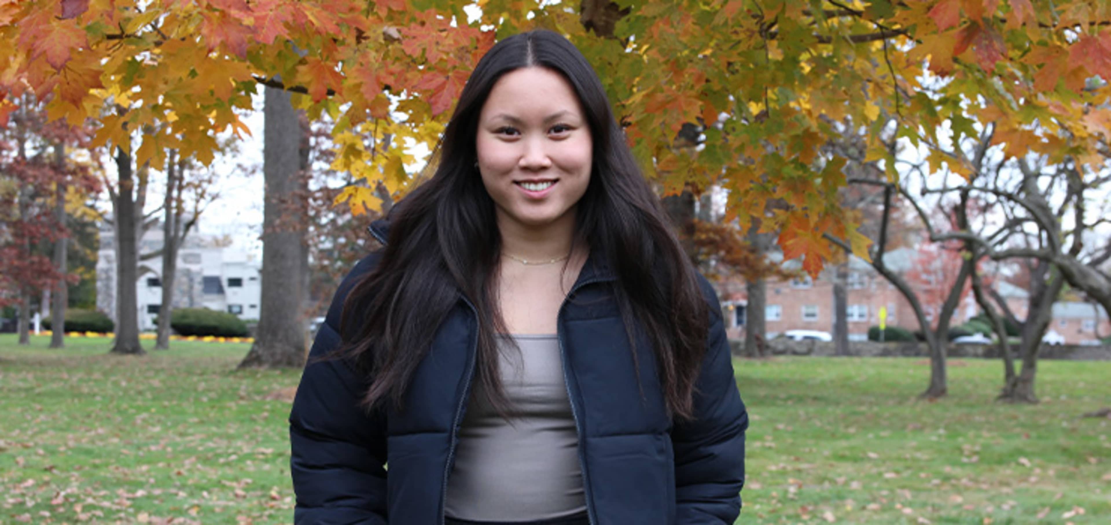 Student with trees behind