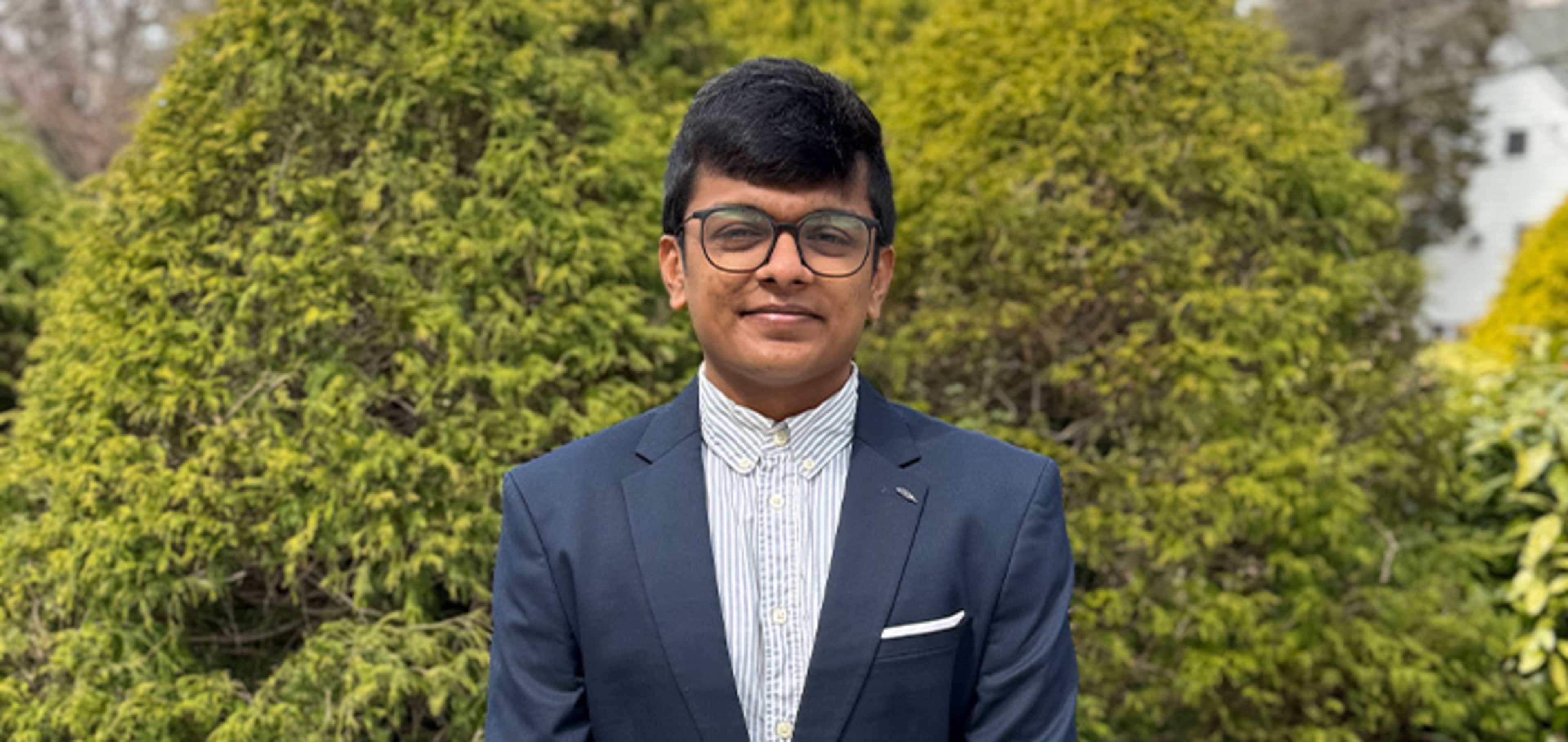 Student with bushes for Background