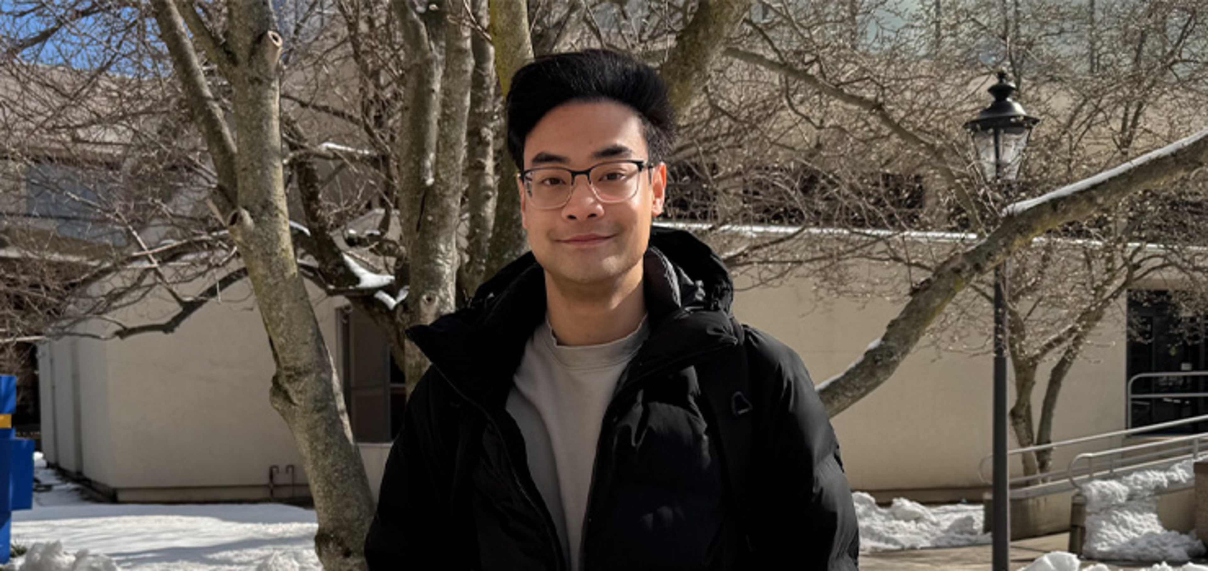 Student in front of a tree