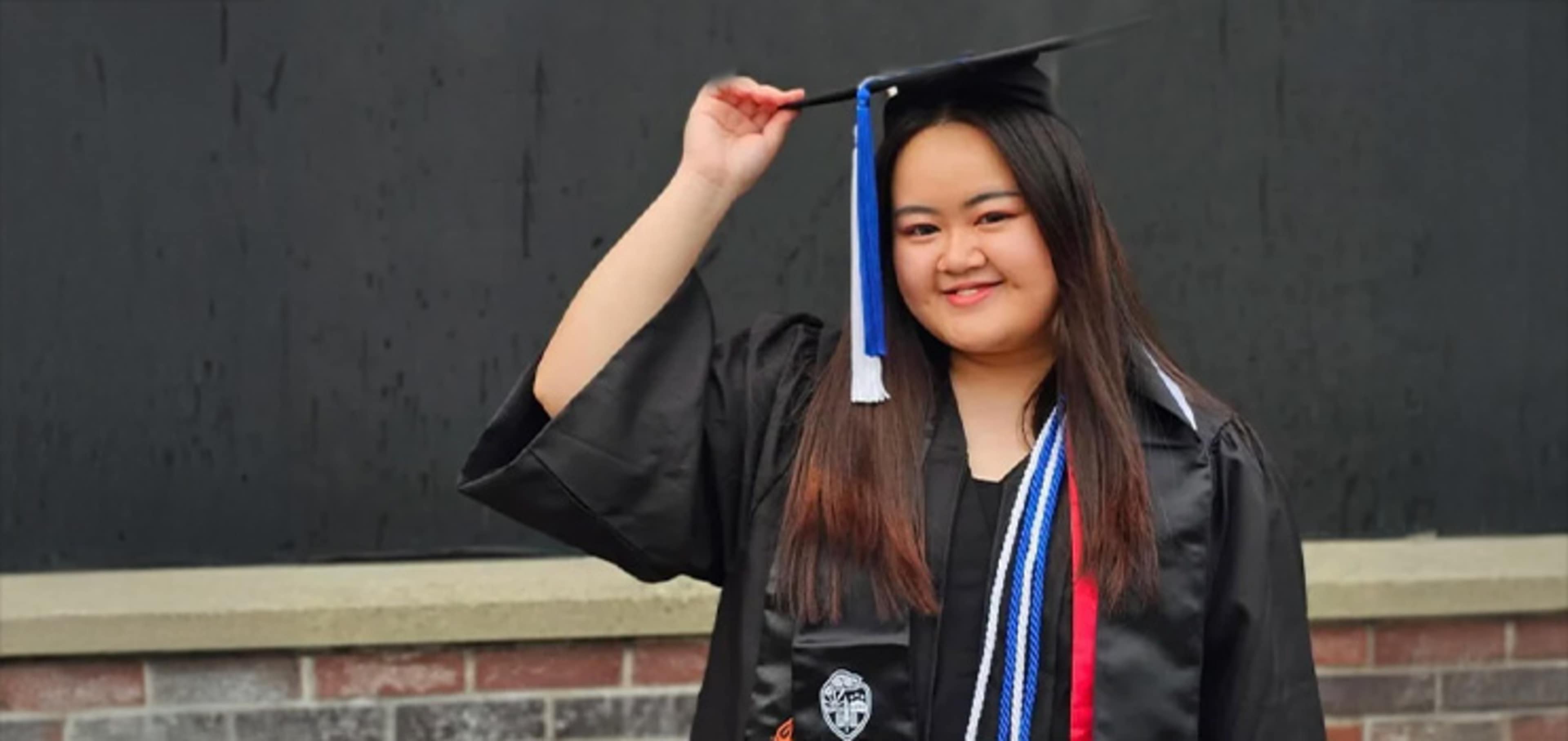 Student holding her graduation hat