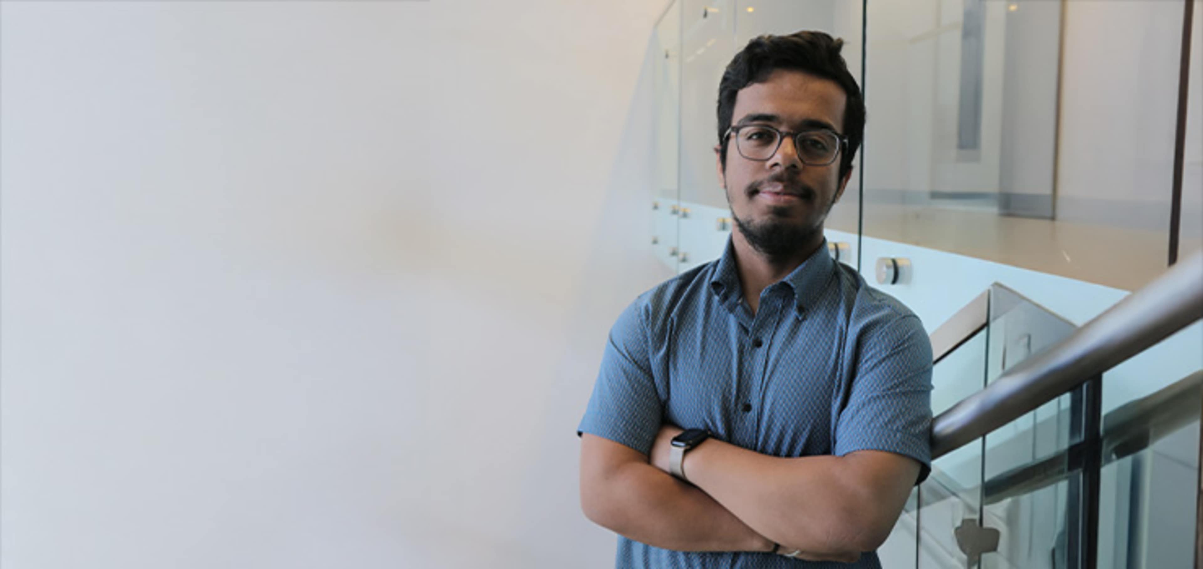 Student next to a glass wall