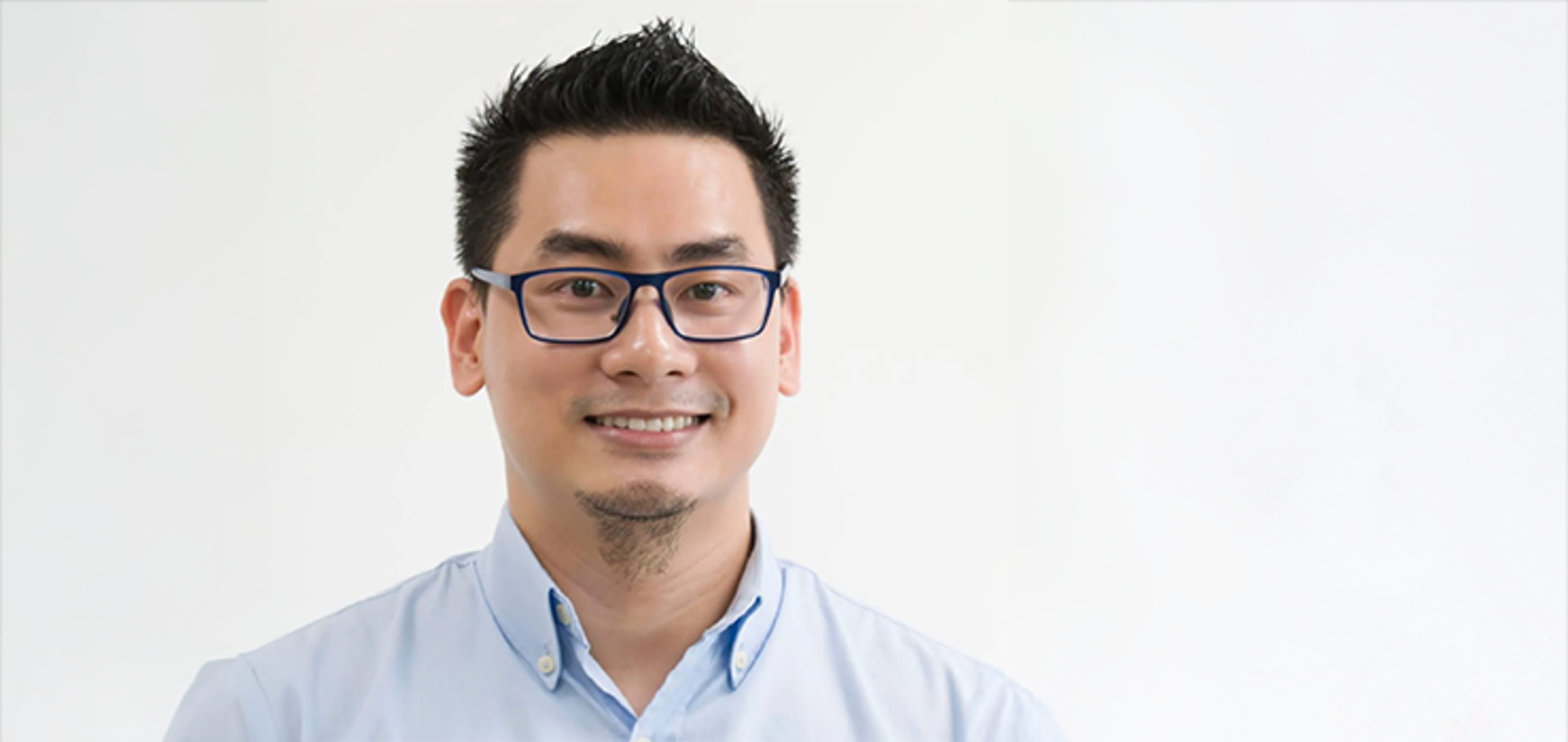 Student smiling in a white background