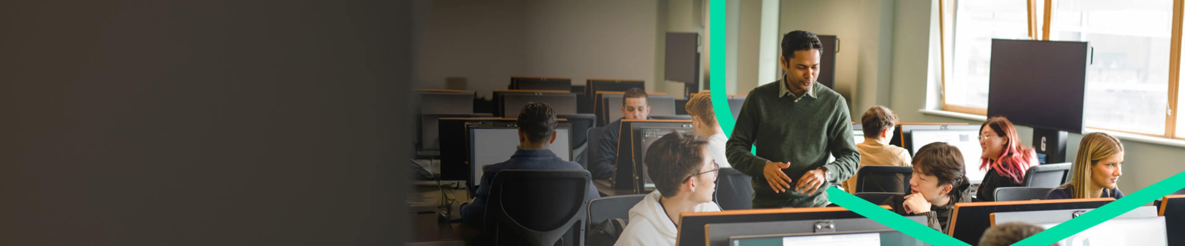 Students with their professor inside a computer lab