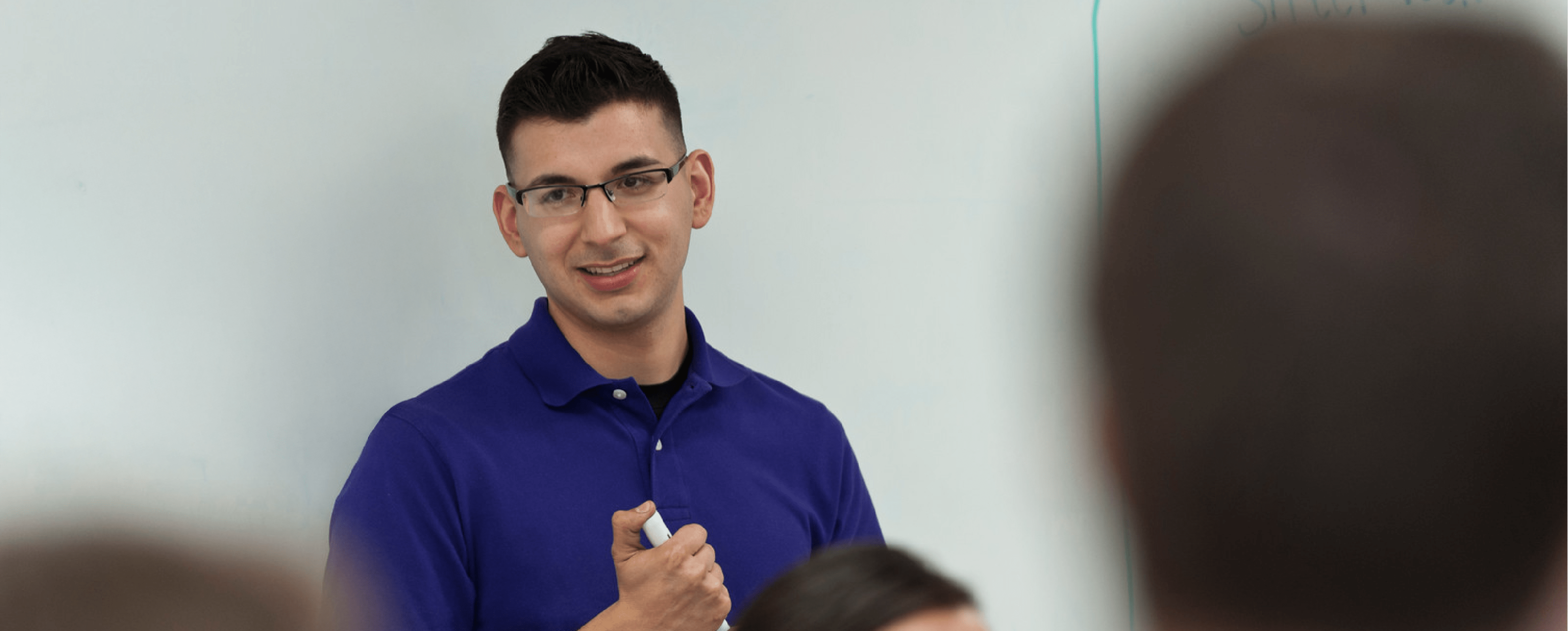 Student in front of a board explaining and giving a lesson for other people