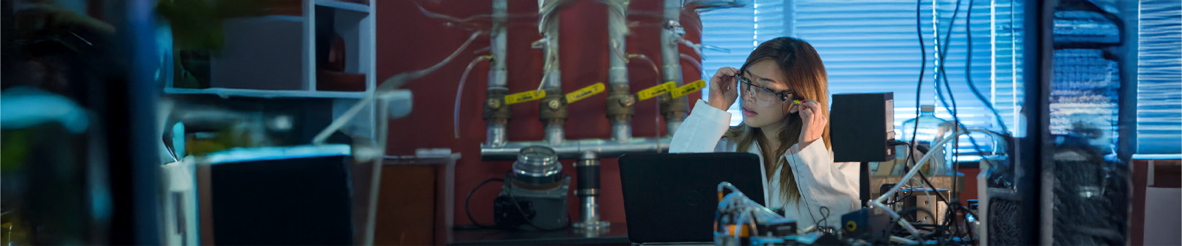 Student wearing lab glasses and studying in a laboratory