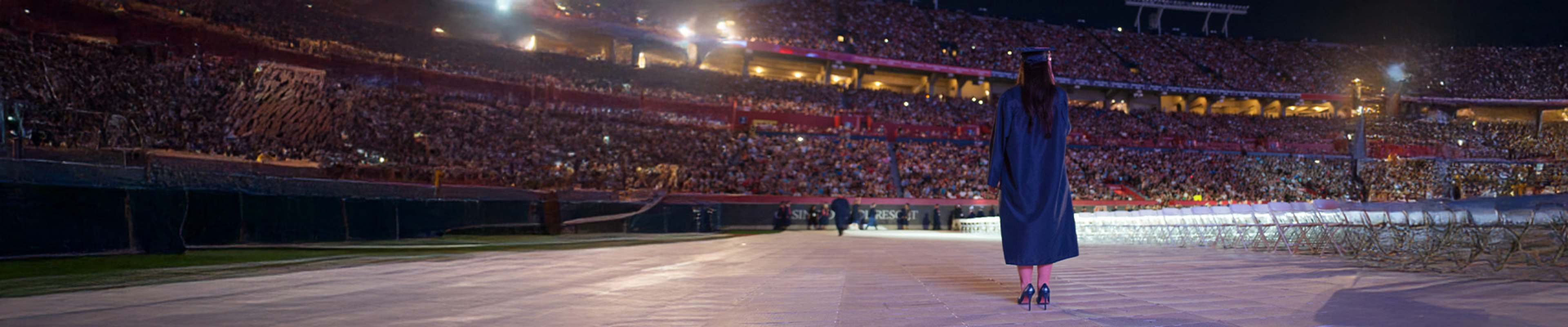 Student in front of a crowd celebrating the graduation ceremony