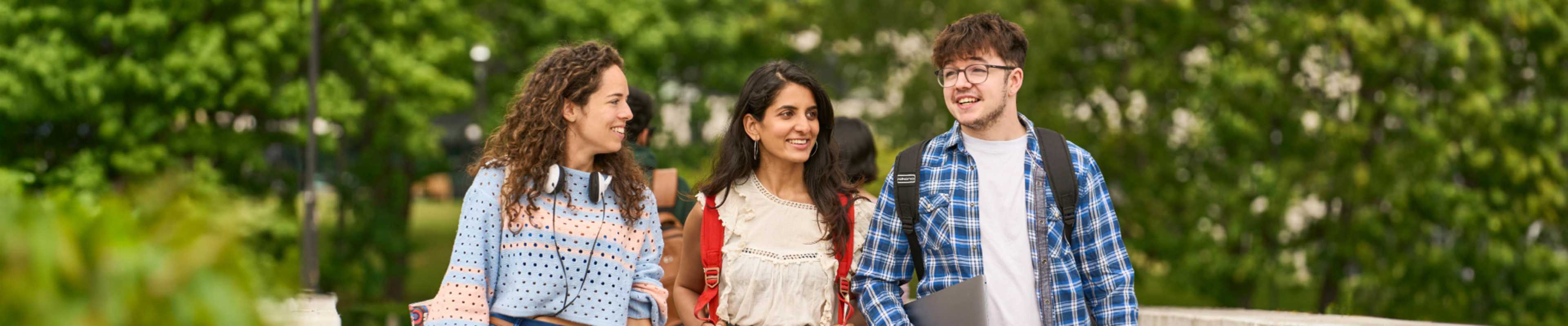 Group of international students walking outside the university campus