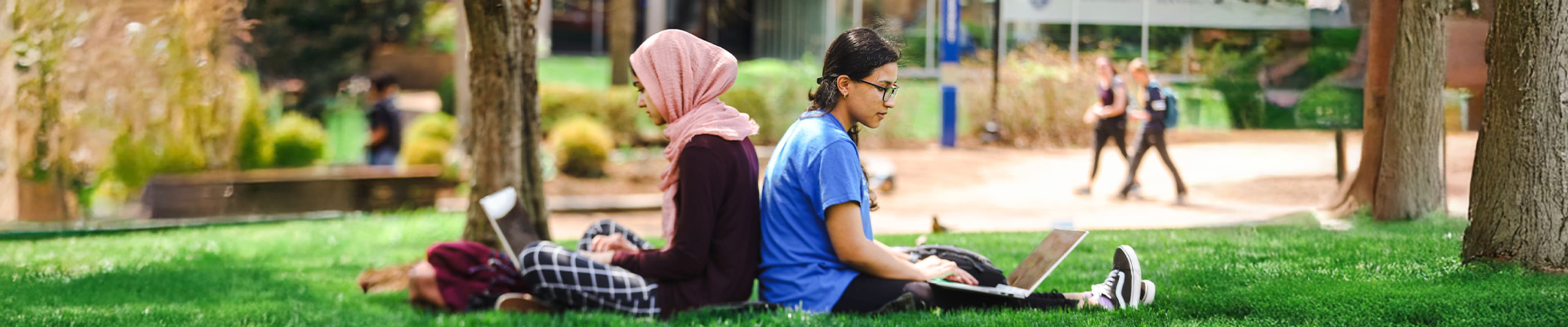 Two students working on their laptops
