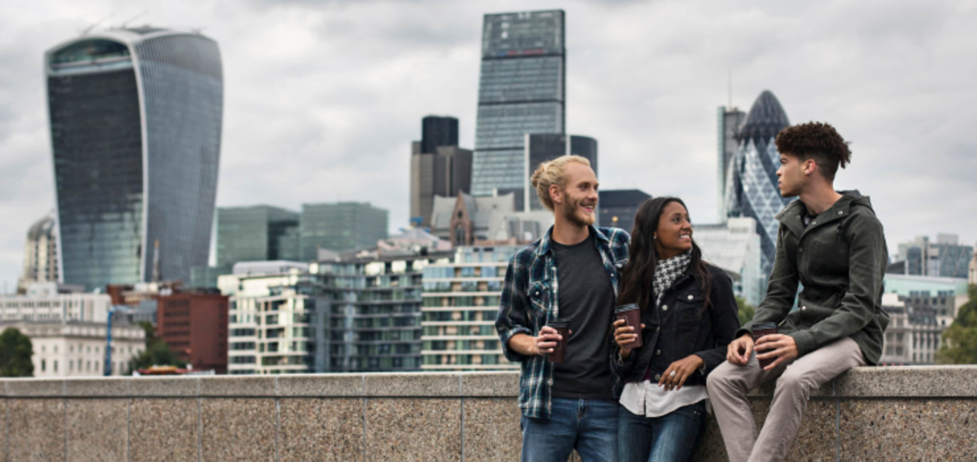 A group of students with the London skyline in the background