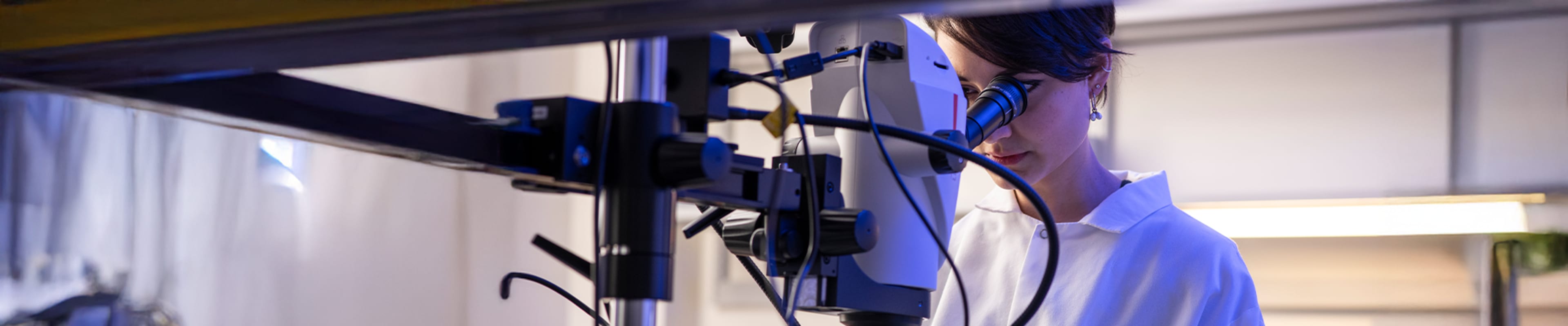 Student at a lab looking trhough a Microscope