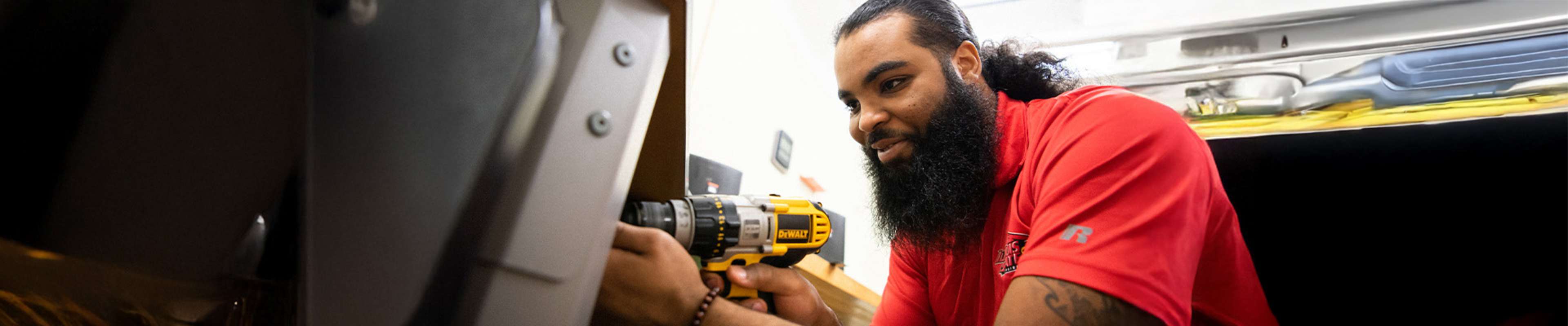 Student working with a drill