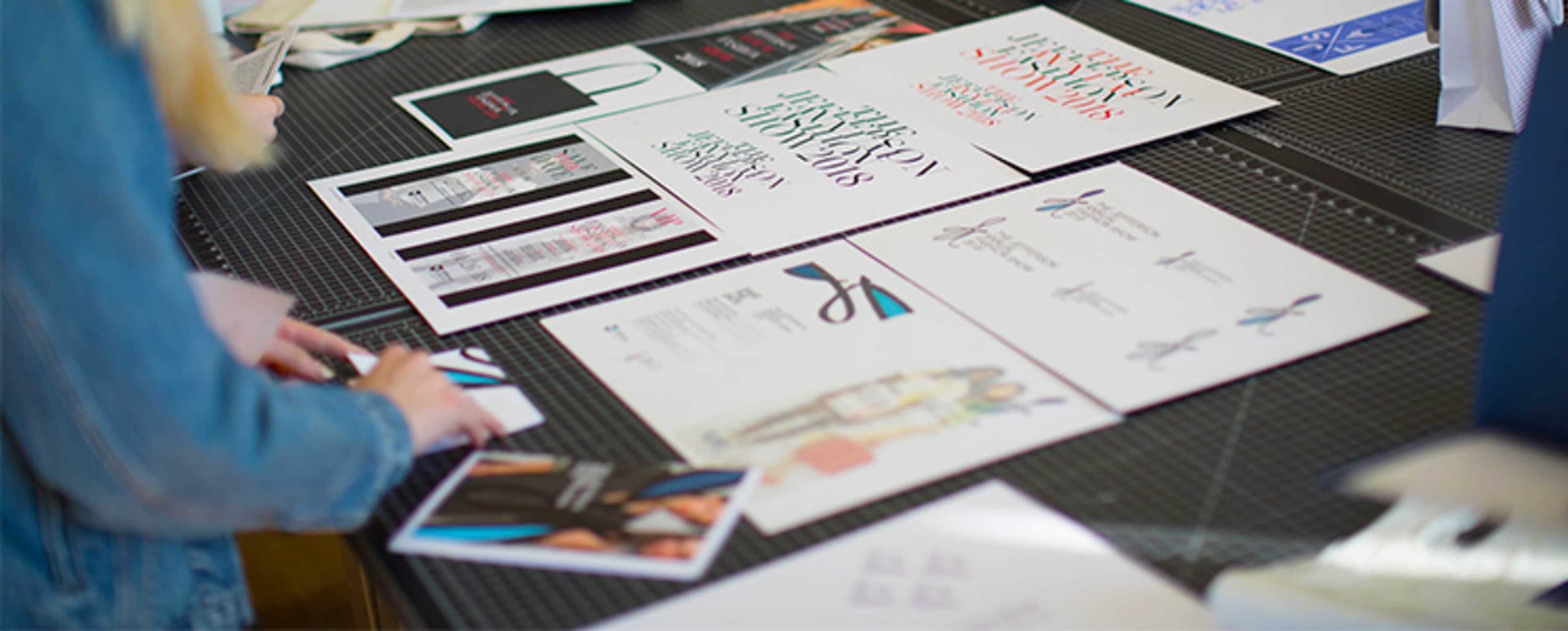 Fahion design students looking at a moodboard