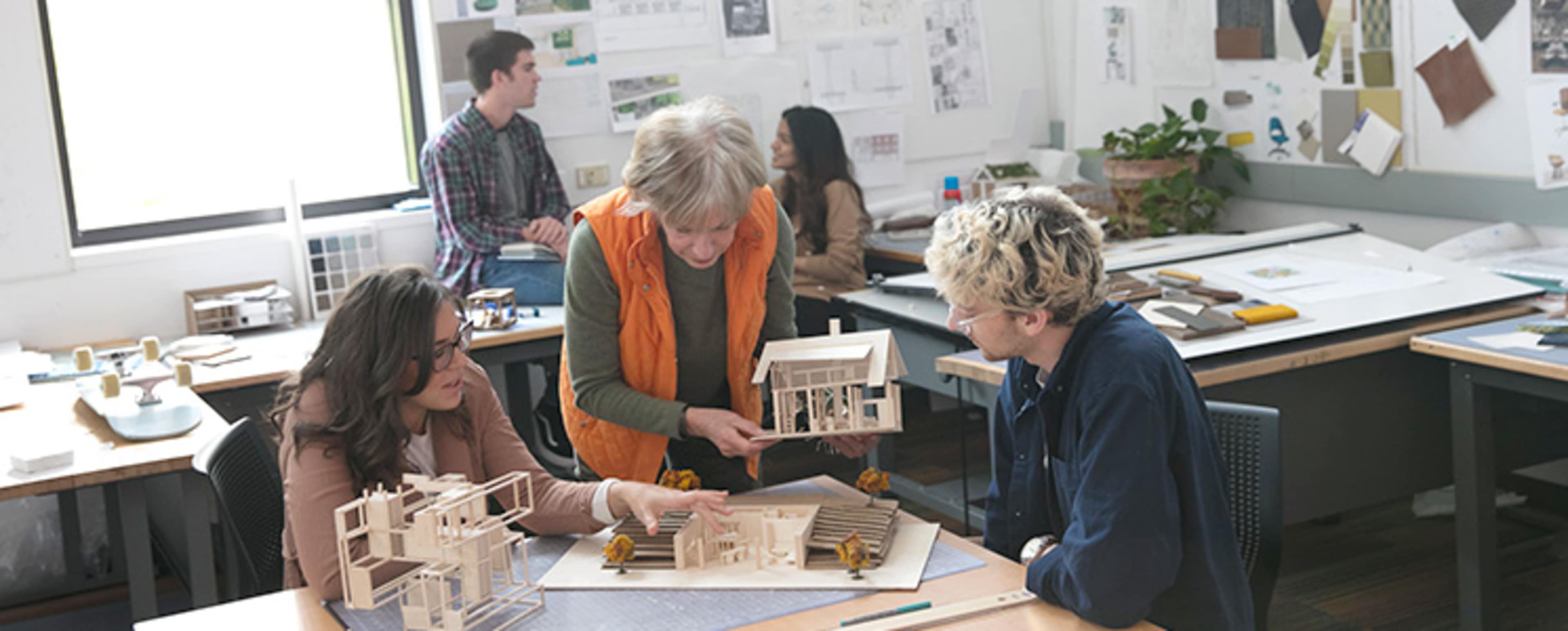 Students and teacher looking at a handmade model