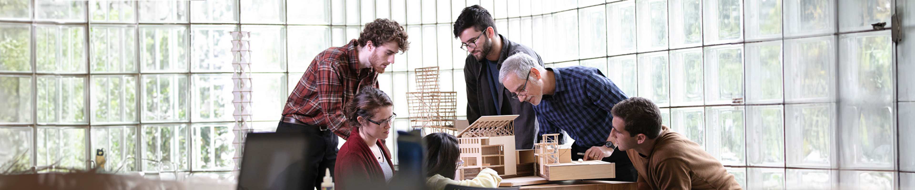 Students and teacher looking at a handmade model
