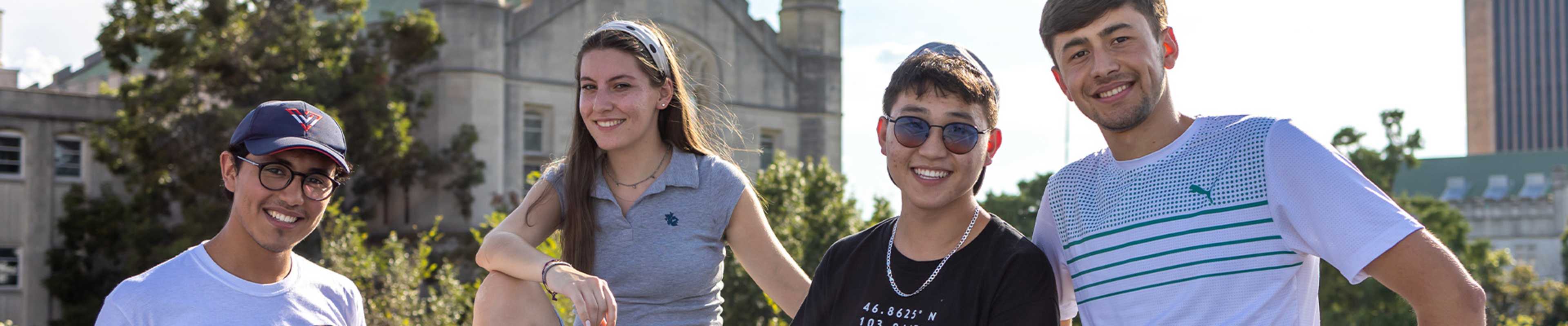 Students inf front of the camera posing and smiling