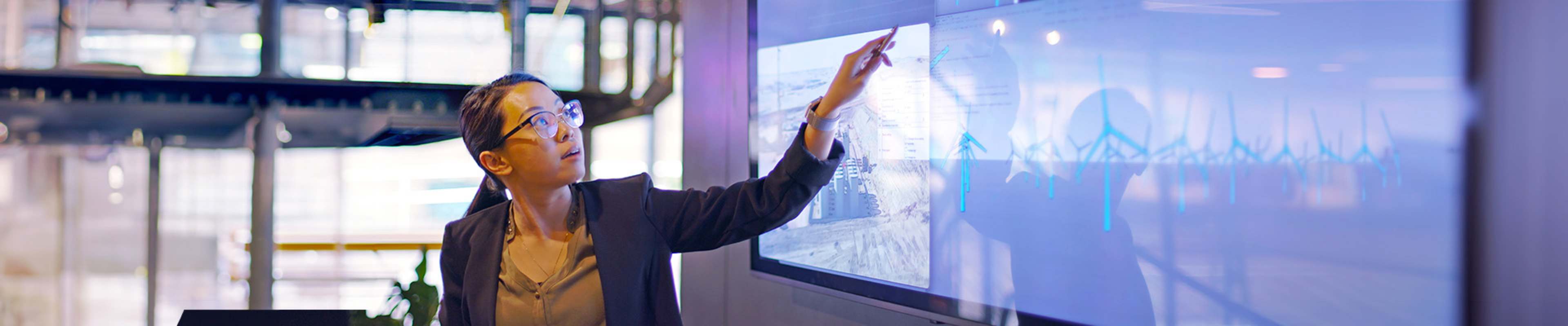 Teacher looking amd pointing at a board
