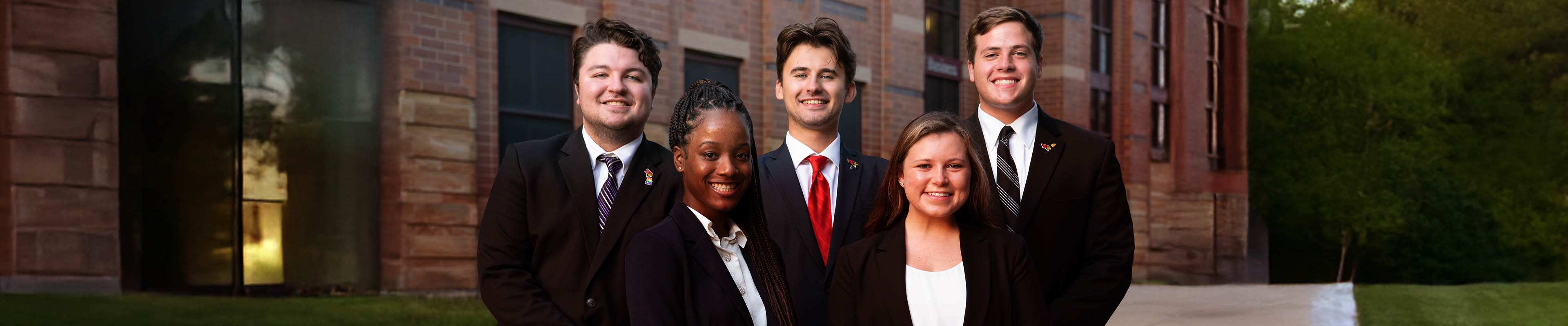 Students smiling while facing the camera