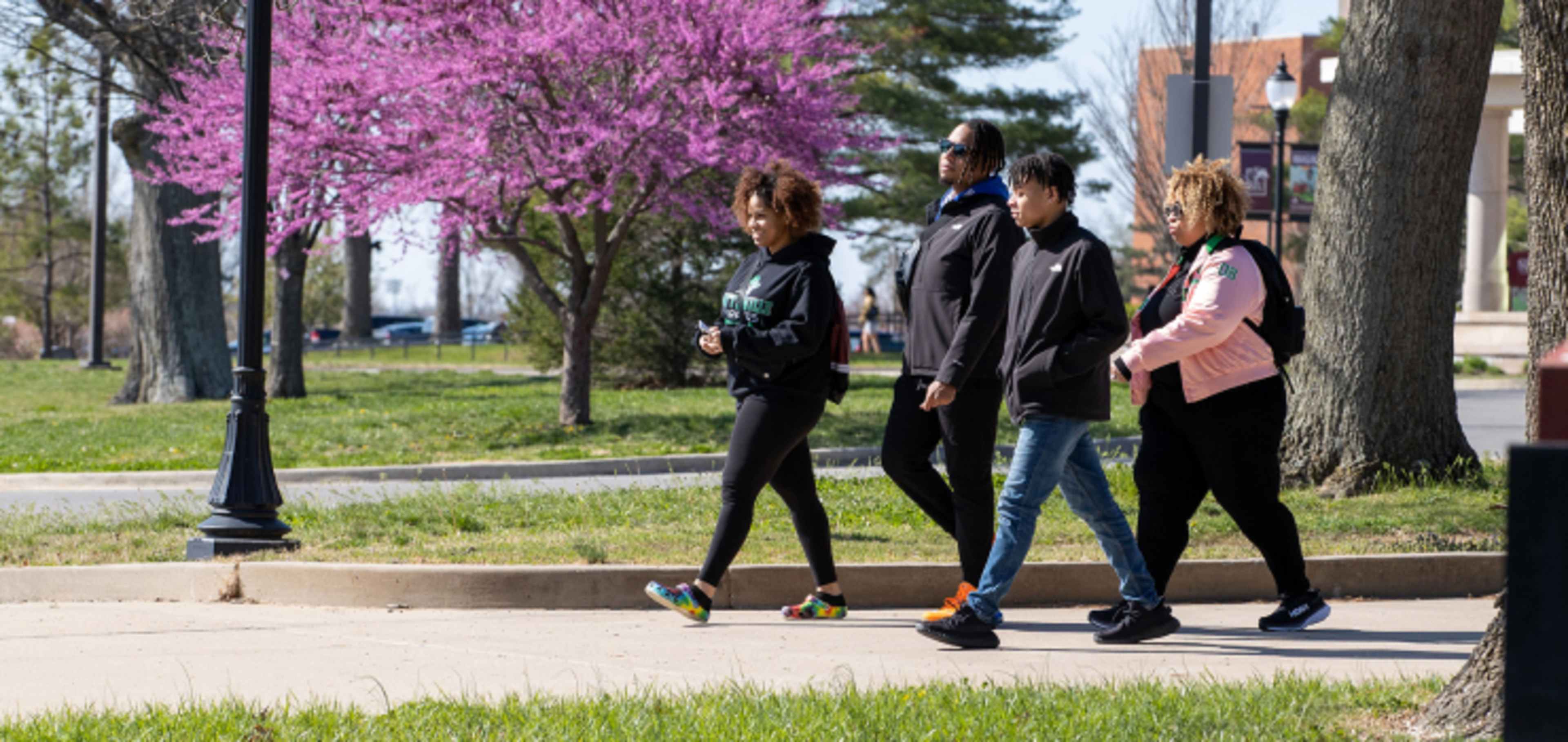 Group of students walking through campus