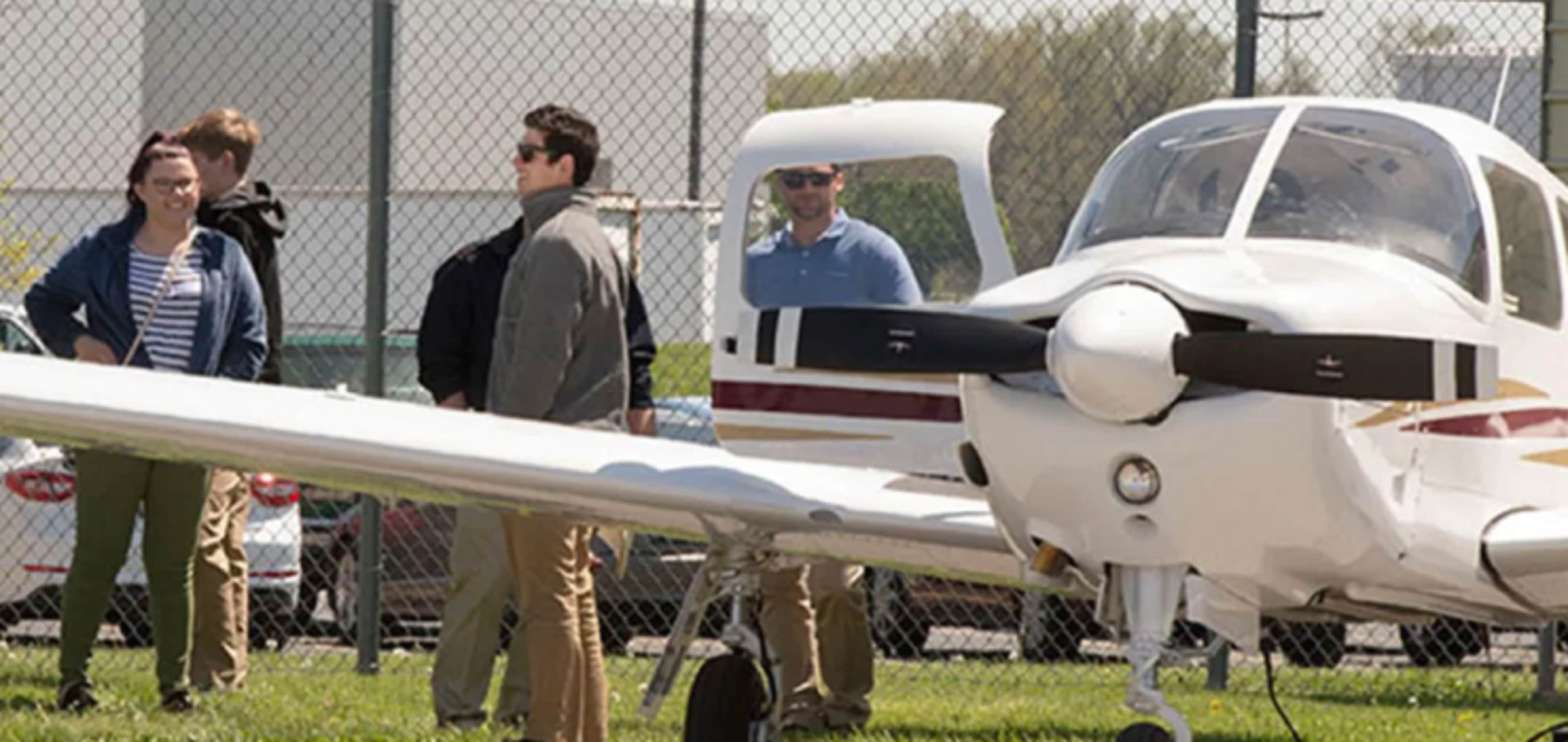 Aviation students gathered around light aircraft