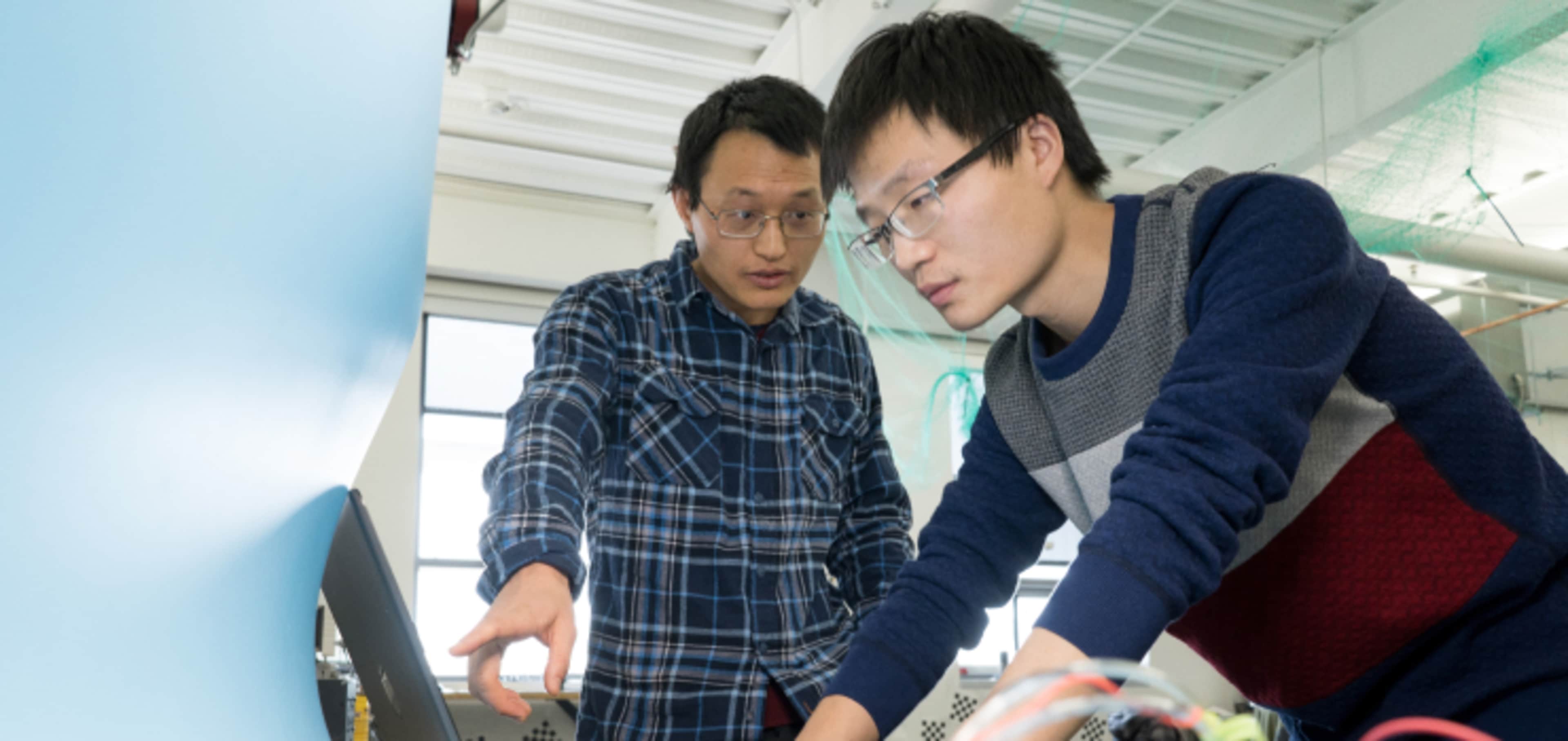 Two international students attending their hands-on engineering training