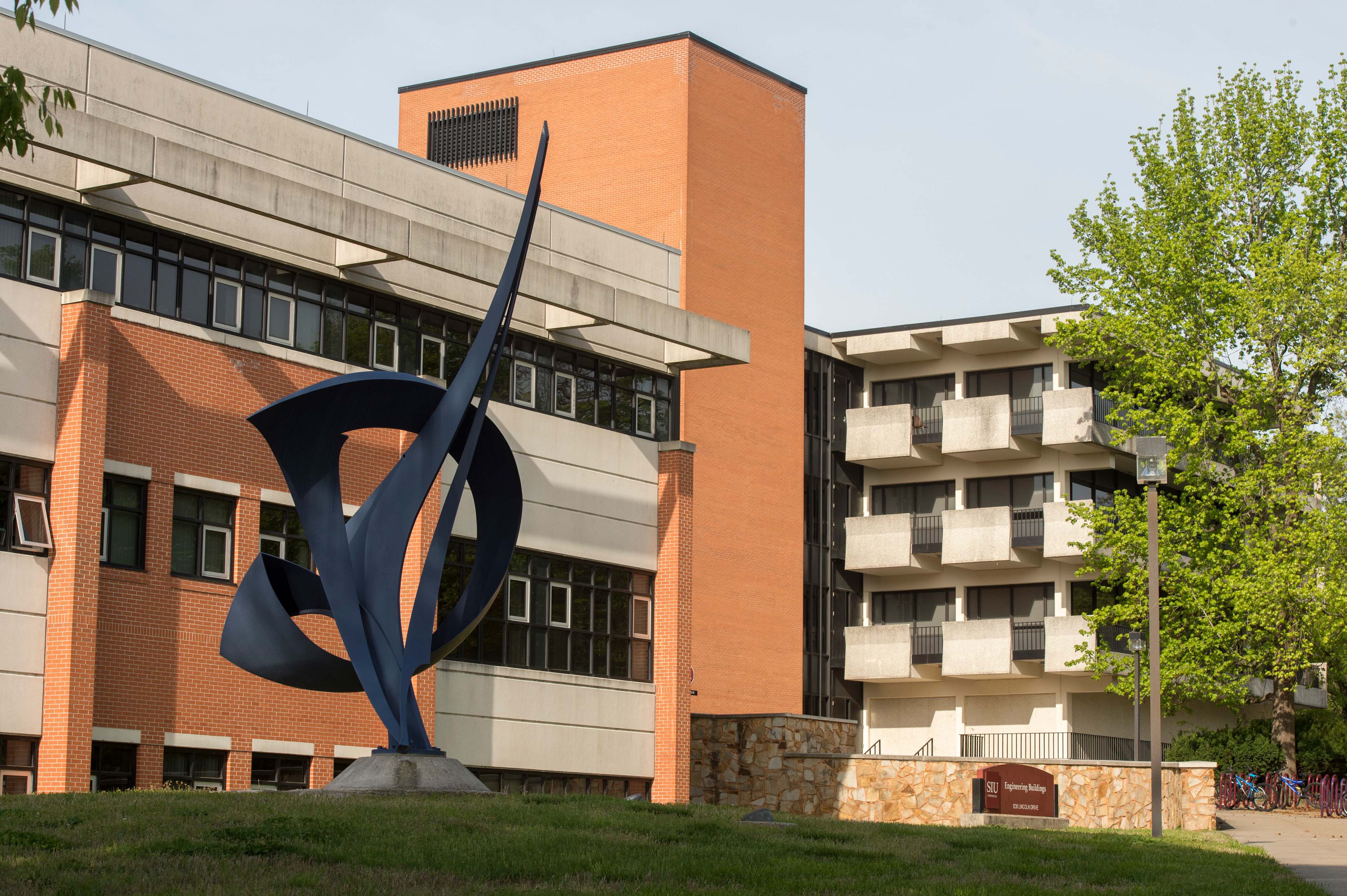 Large sculpture in front of campus building