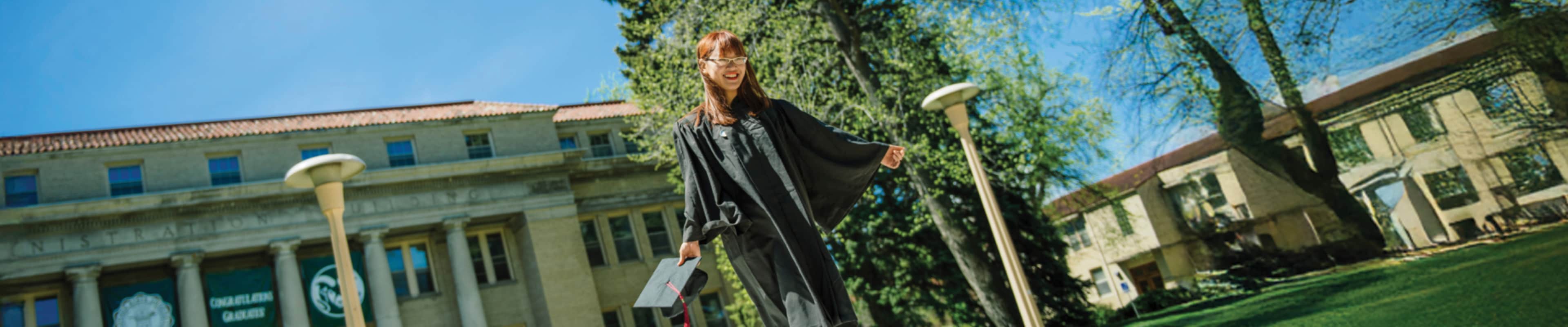 International student standing joyfully at her graduation